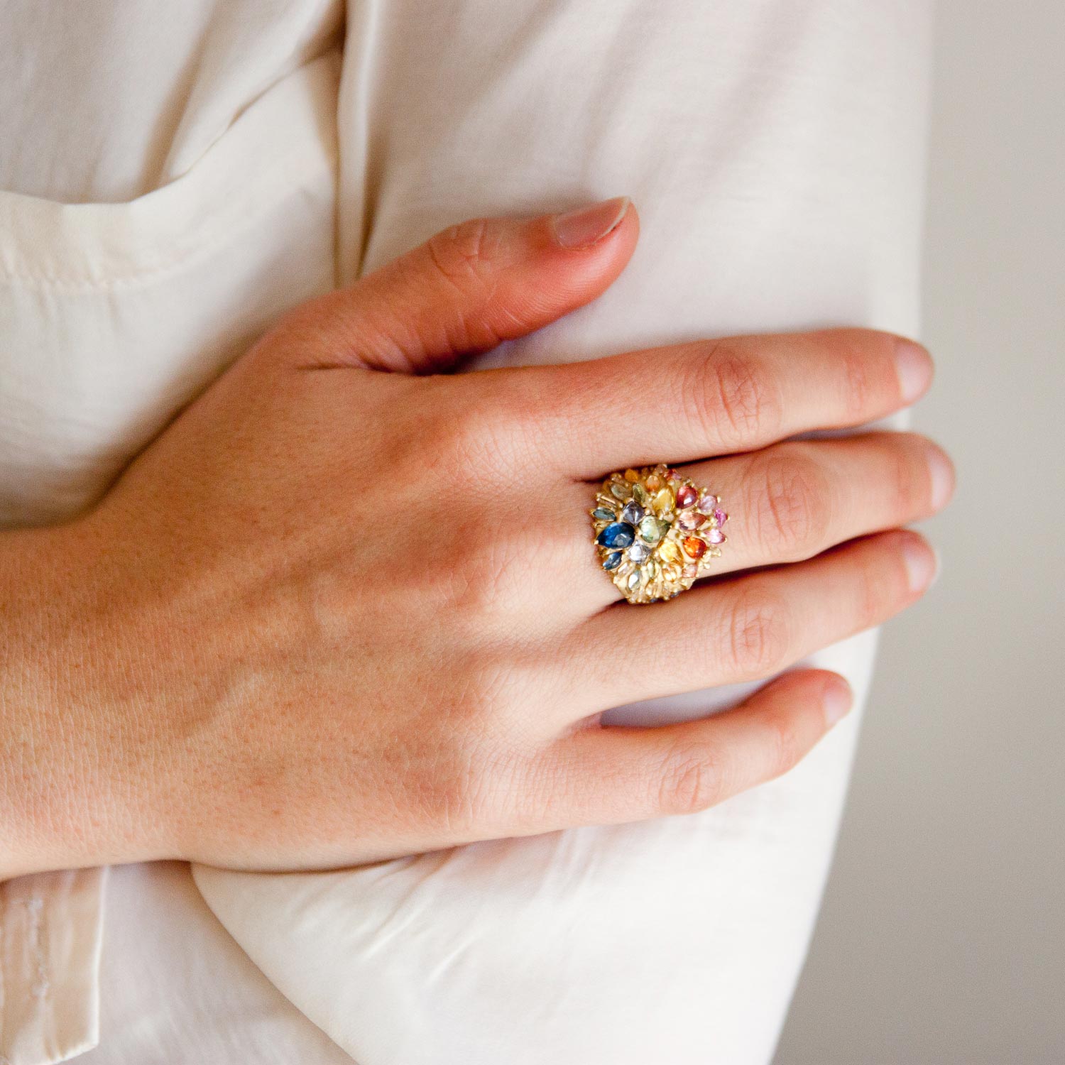 Polly Wales: 18K Gold Ourika Rainbow Butterfly Shield Ring Encrusted with Large Multi Colored Pear and Marquise Sapphires, with Baguette diamonds and Rainbow Sapphires 3.95ct Sapphires, .34ct Diamonds