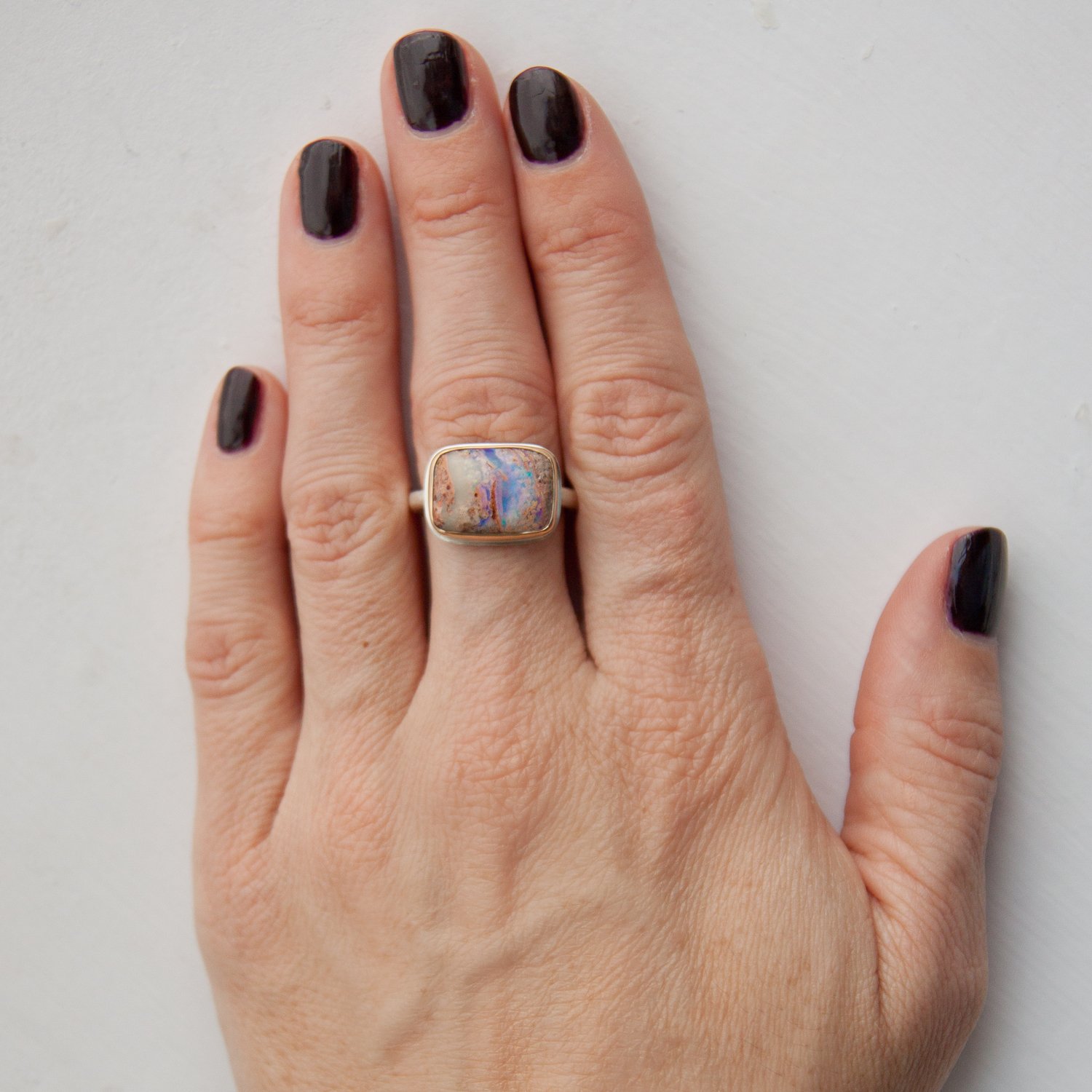 Jamie Joseph: SS & 14k gold ring with small rectangular opalized wood on Egyptian band