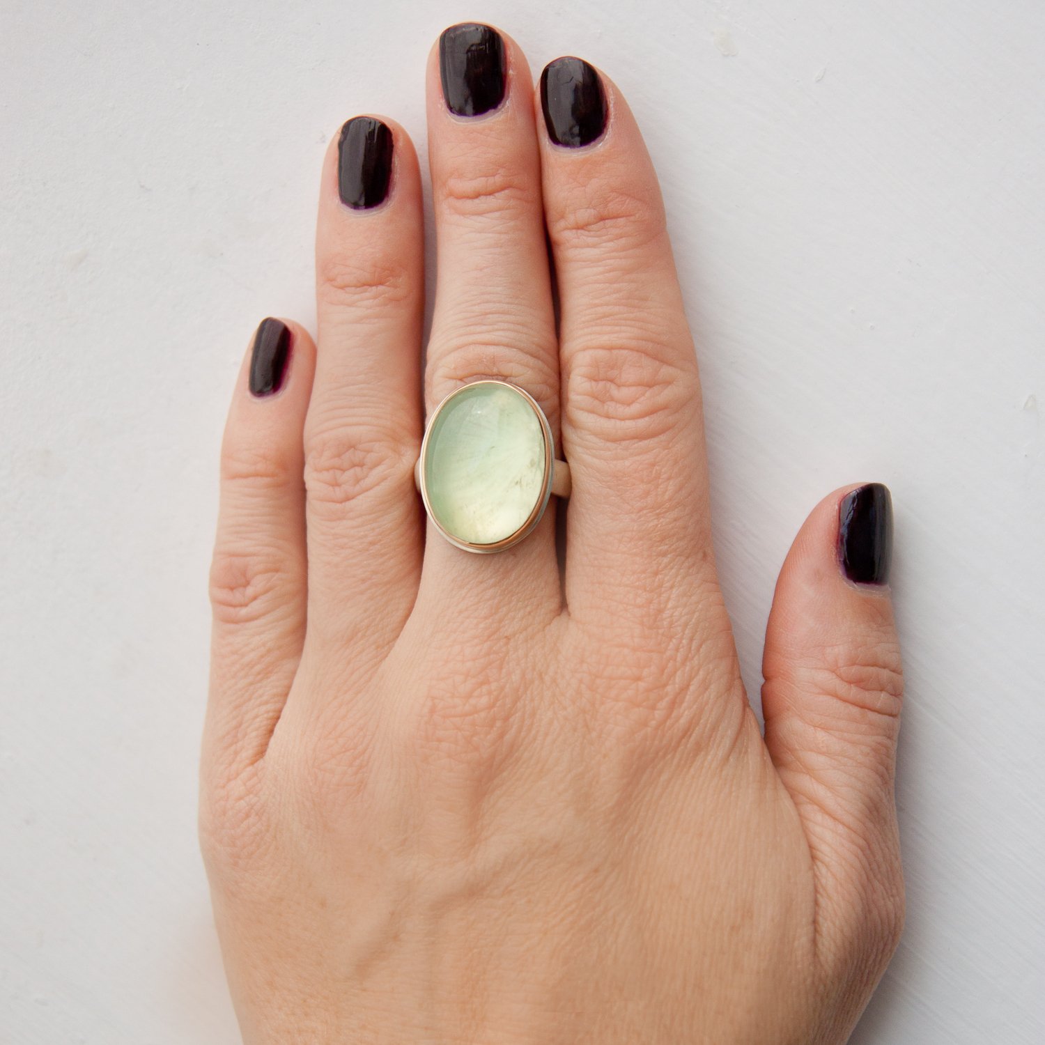 Jamie Joseph: SS & 14k gold ring with vertical oval smooth prehnite on groovy band