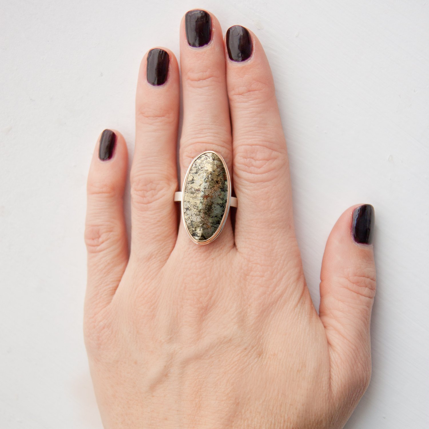 Jamie Joseph: SS & 14k gold ring with vertical oval pyrite on X band