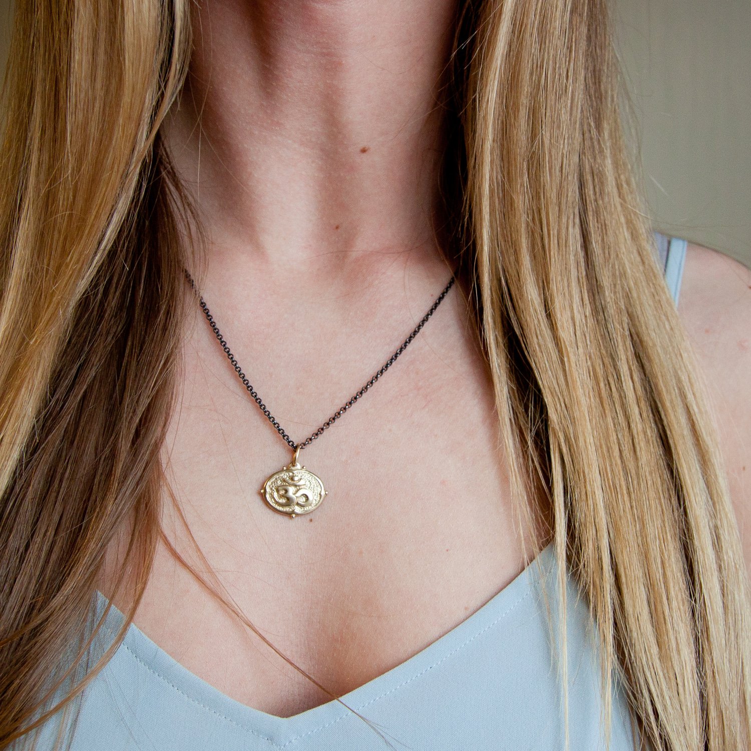 Erica Molinari: 14K lotus and om charm