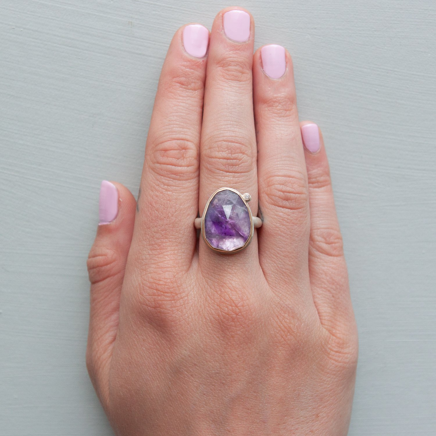 Jamie Joseph: SS & 14k gold ring with vertical asymmetrical rose cut amethyst and .025ct satellite diamond on organic band size 6.75