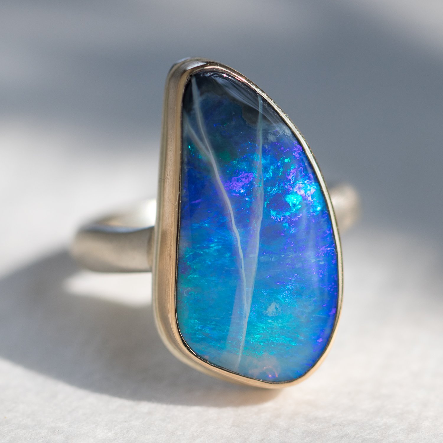 Jamie Joseph: SS & 14k gold w/ Vertical asymmetrical black opal on organic band