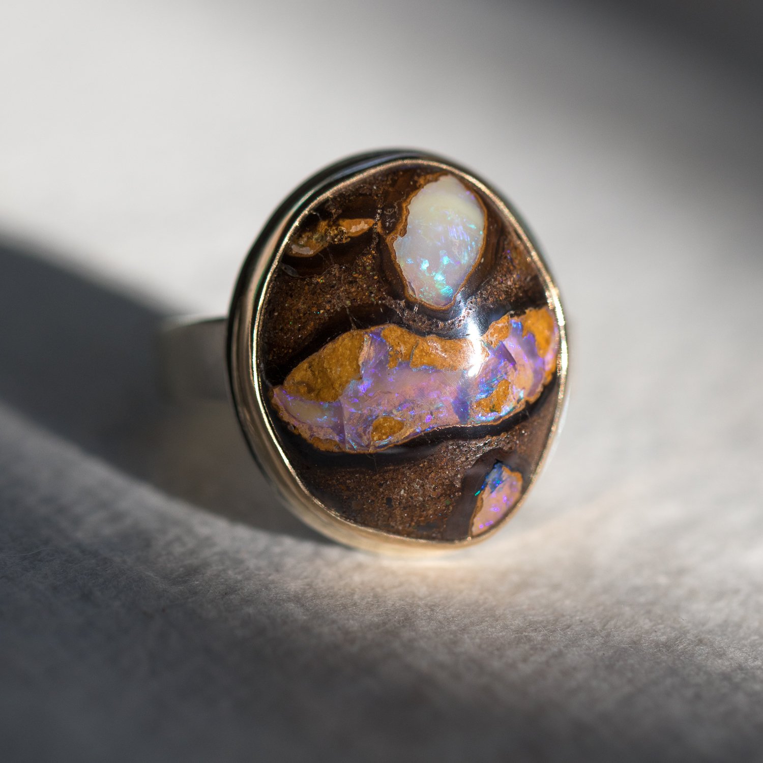 Jamie Joseph: SS & 14k Gold ring w/ Vertical Asymmetrical Boulder Opal on Tapered X band