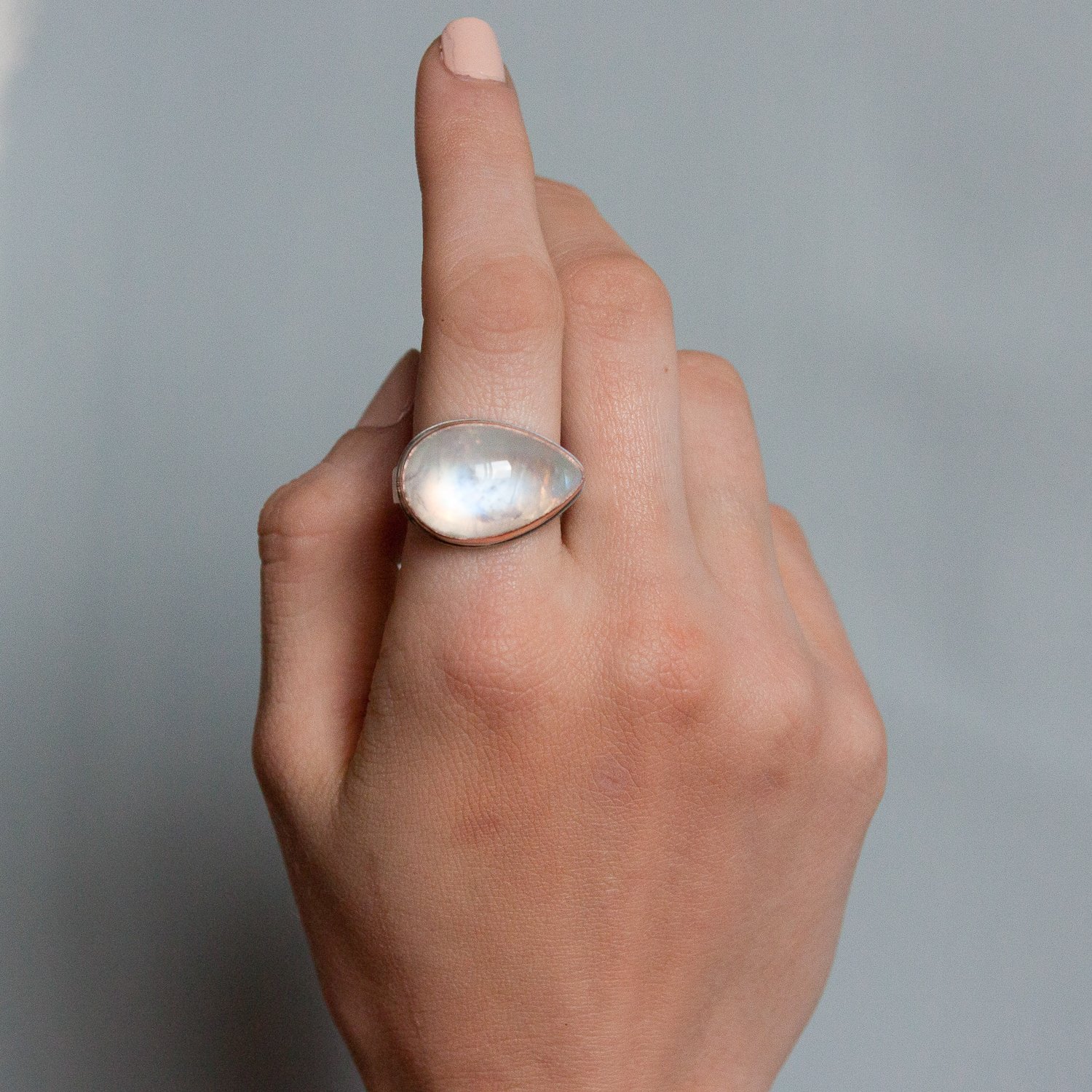 Jamie Joseph: SS & 14k rose gold ring w/ teardrop smooth white rainbow moonstone on live edge band