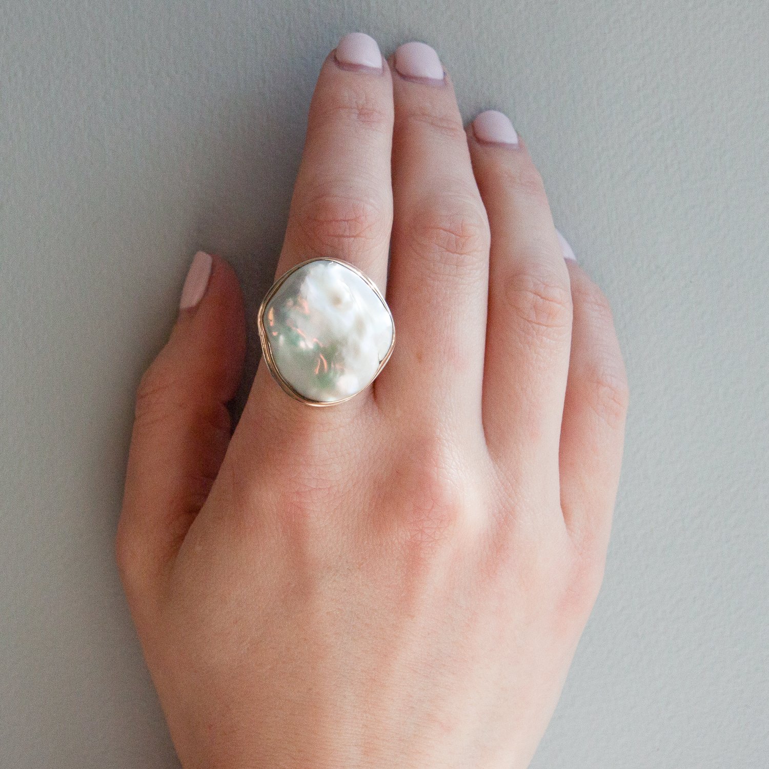 Jamie Joseph: SS & 14k gold ring w/ large vertical asymmetrical cultured white pearl on tapered y band
