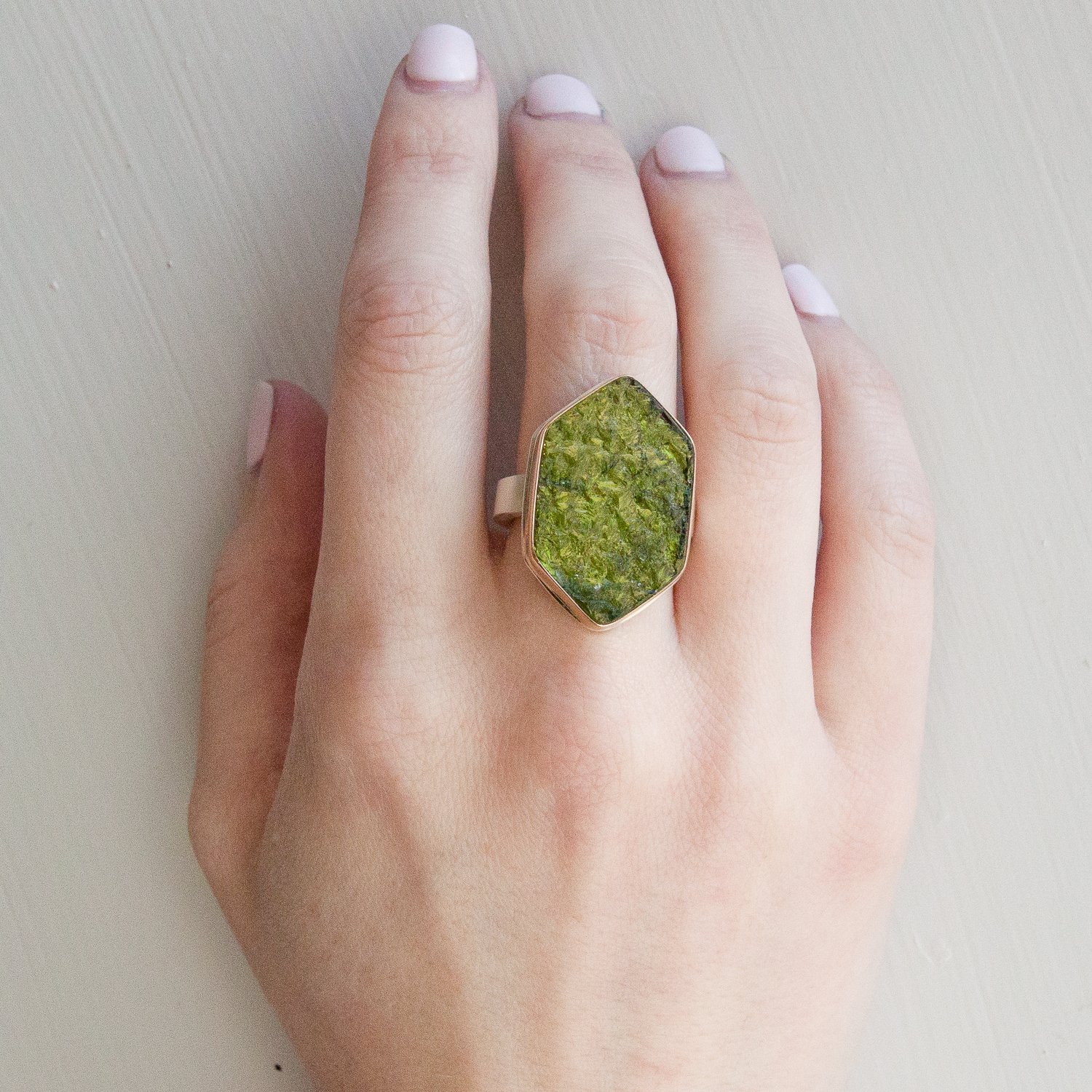 Jamie Joseph: SS & 14k gold ring w/ vertical large hexagonal surface cut green tourmaline on y band