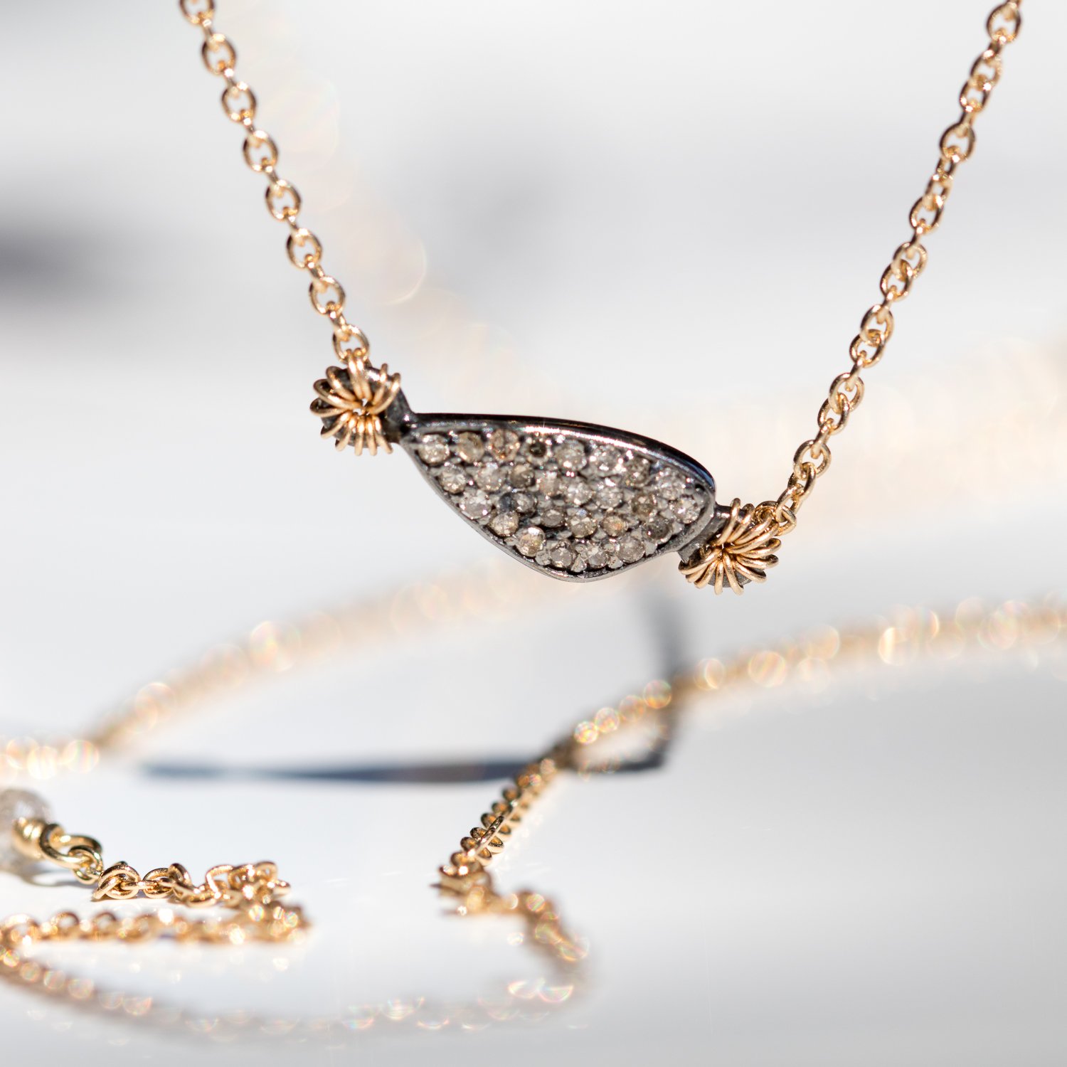 Dana Kellin Fine: 14K gold necklace with horizontal asymmetrical oxidized sterling silver and pave diamond pendant