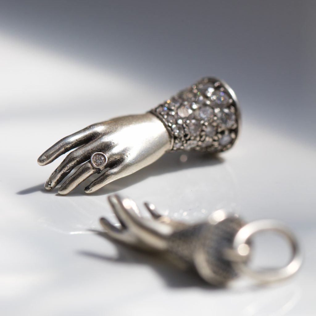 silver hand charm by Erica Molinari