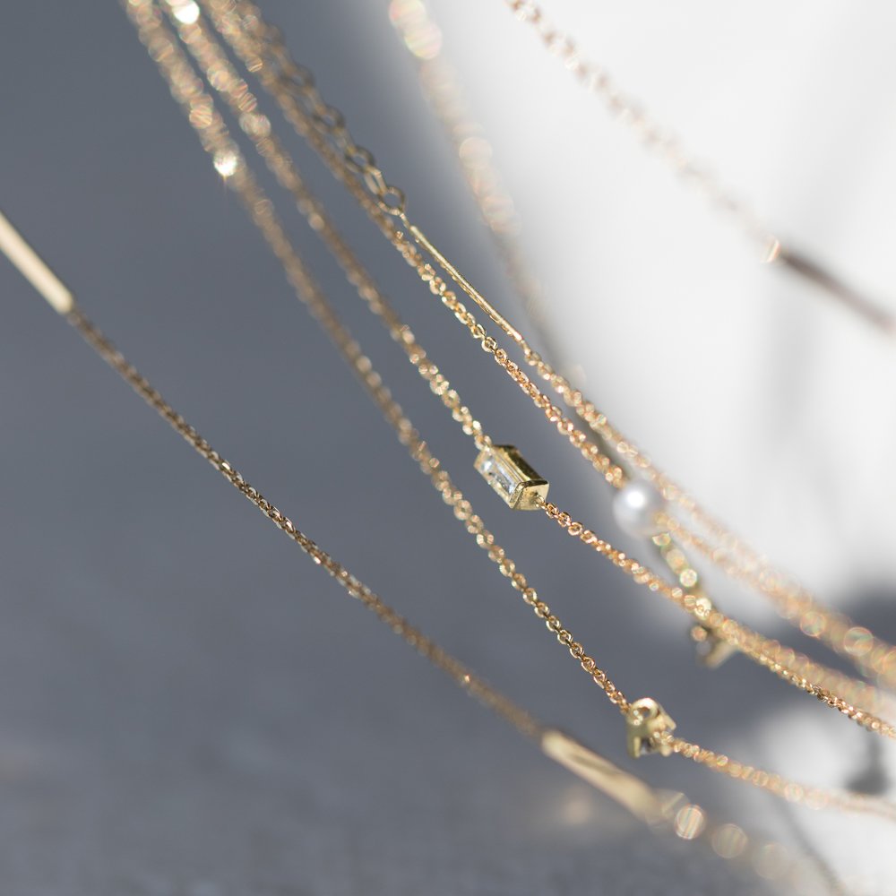 Gold chain necklaces and bracelets by Sweet Pea