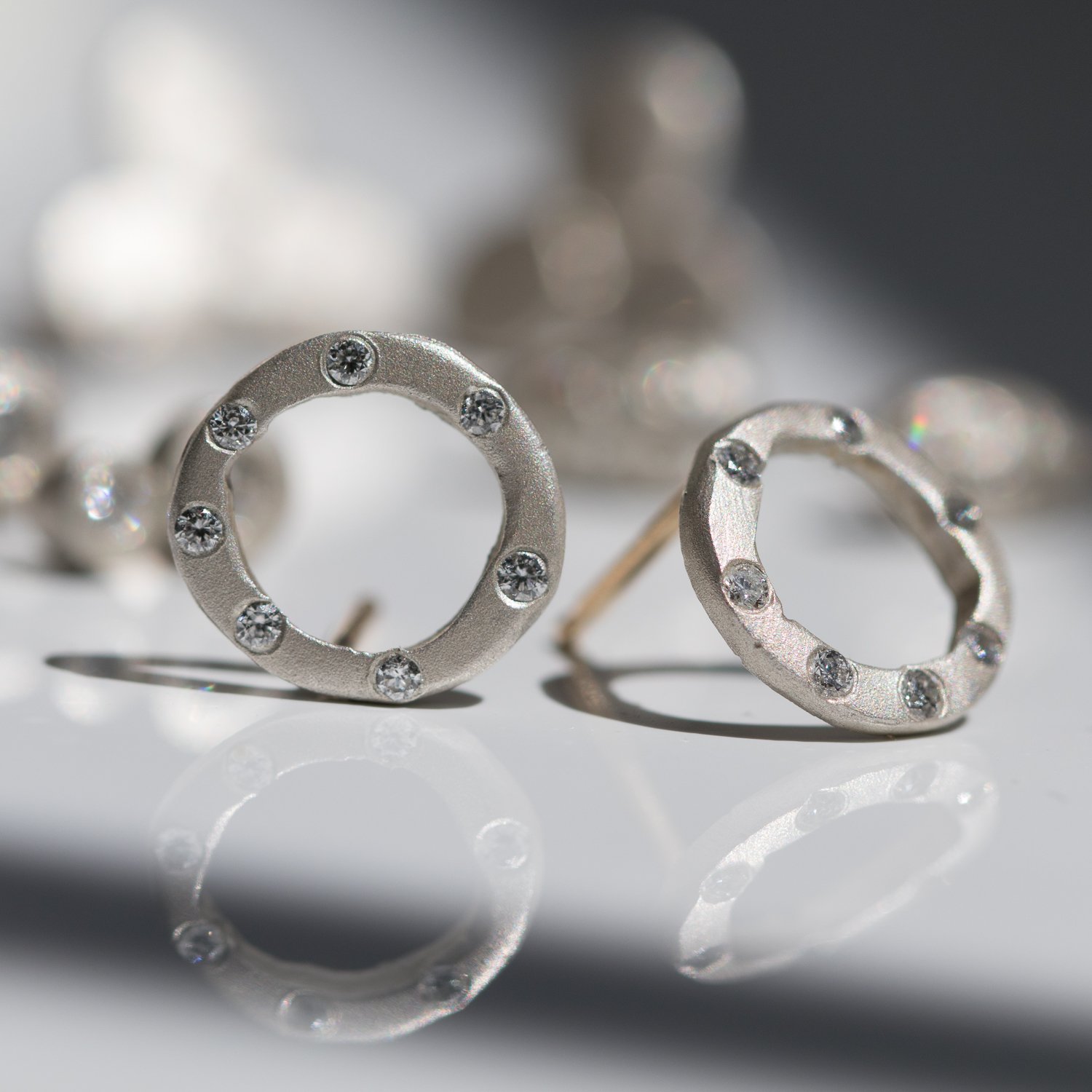 Saundra Messinger: medium open orb posts with 14 diamonds .14tcw