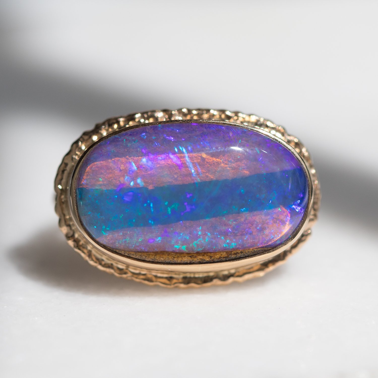 Jamie Joseph:14k Gold Ring w/ oval opalized wood on ruffled platform/delicate facet band