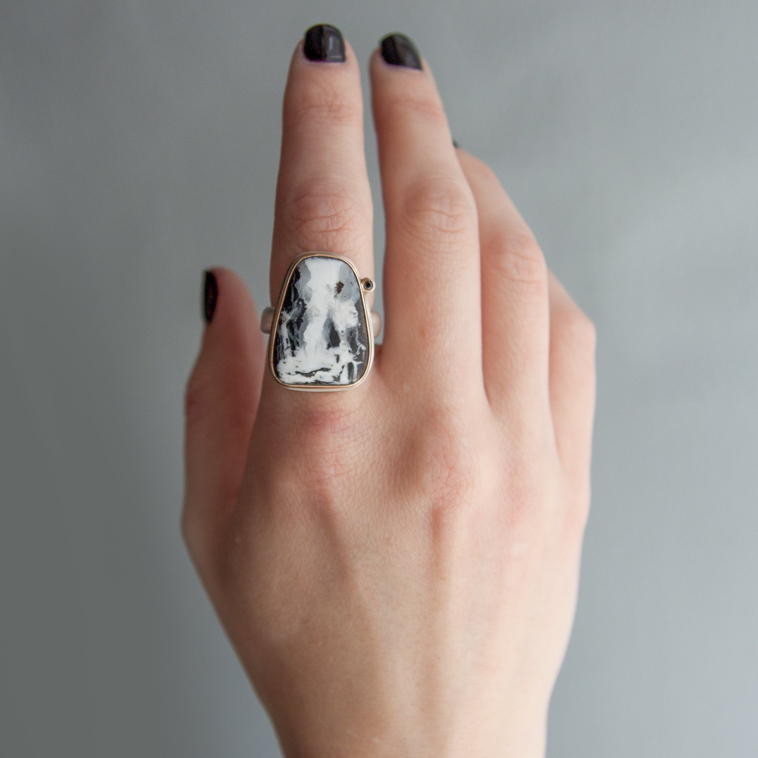 Jamie Joseph: SS and 14k Gold Ring w/ asymmetrical white buffalo turquoise and .025 black satellite diamond on comfort band