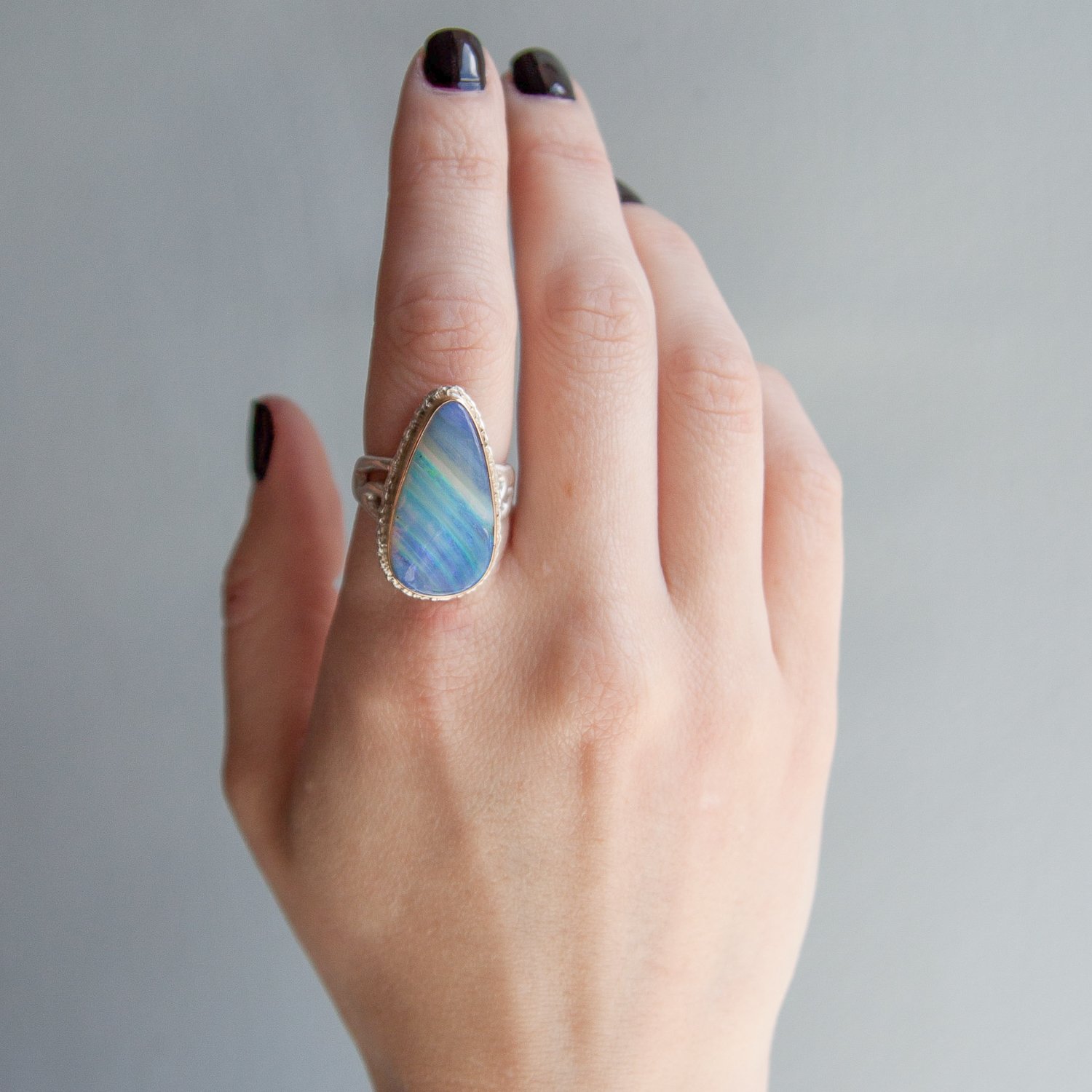 Jamie Joseph: SS and 14k Gold Ring w/ teardrop boulder opal on lava platform/madrona band