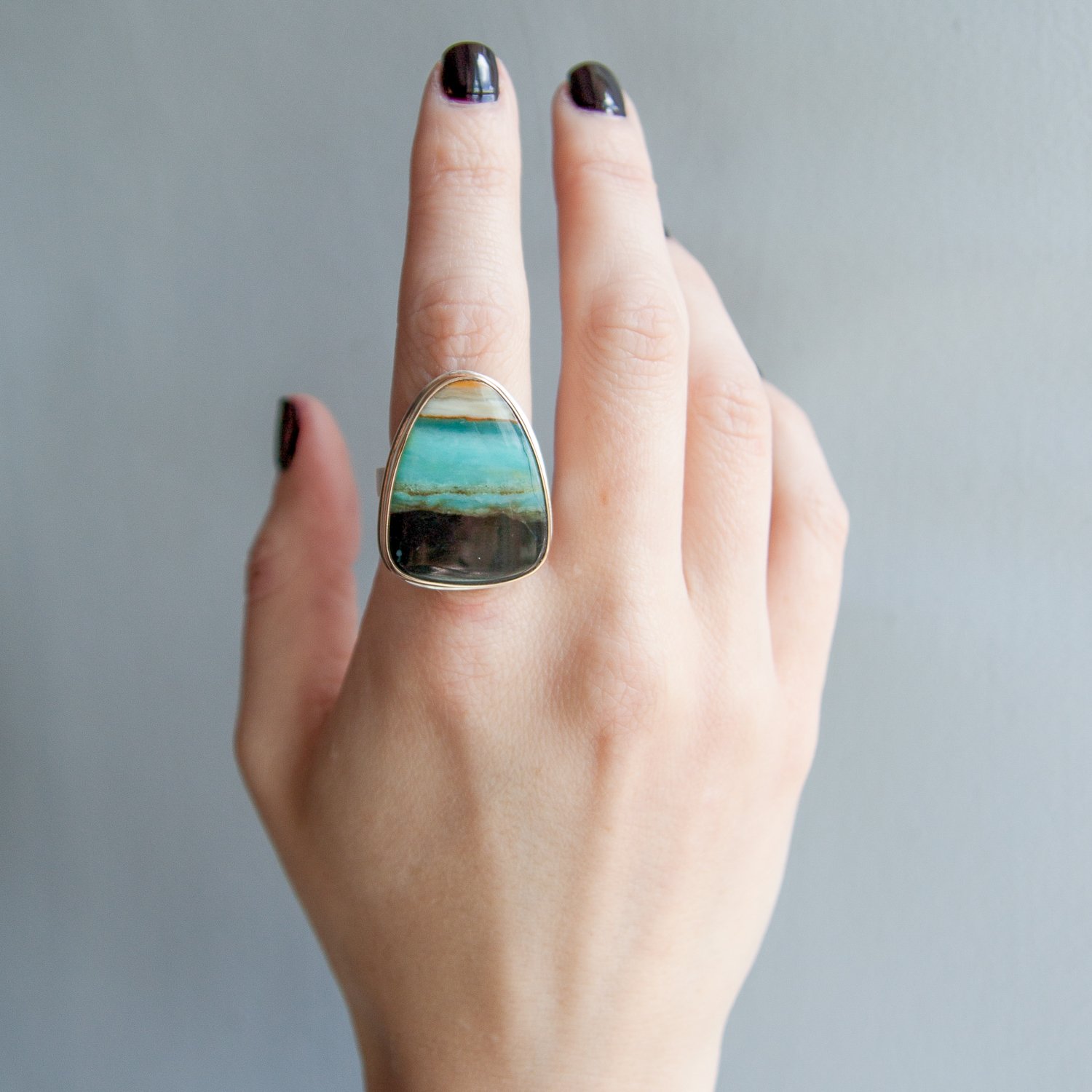 Jamie Joseph: sterling 14k gold ring w/ large vertical asymmetrical smooth indonesian blue petrified opalized wood on tapered X band