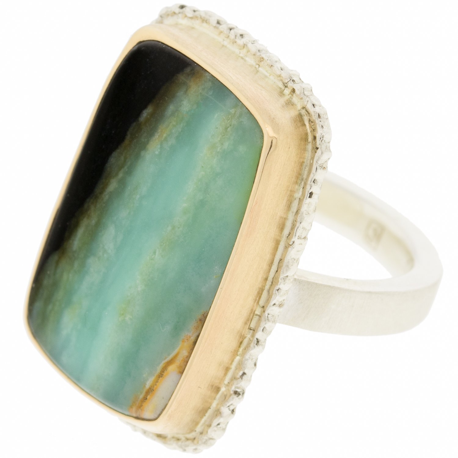 Jamie Joseph: Sterling & 14K gold ring w/vertical rectangular Indonesian Blue Fossilized Opalized Wood on lava platform and X band