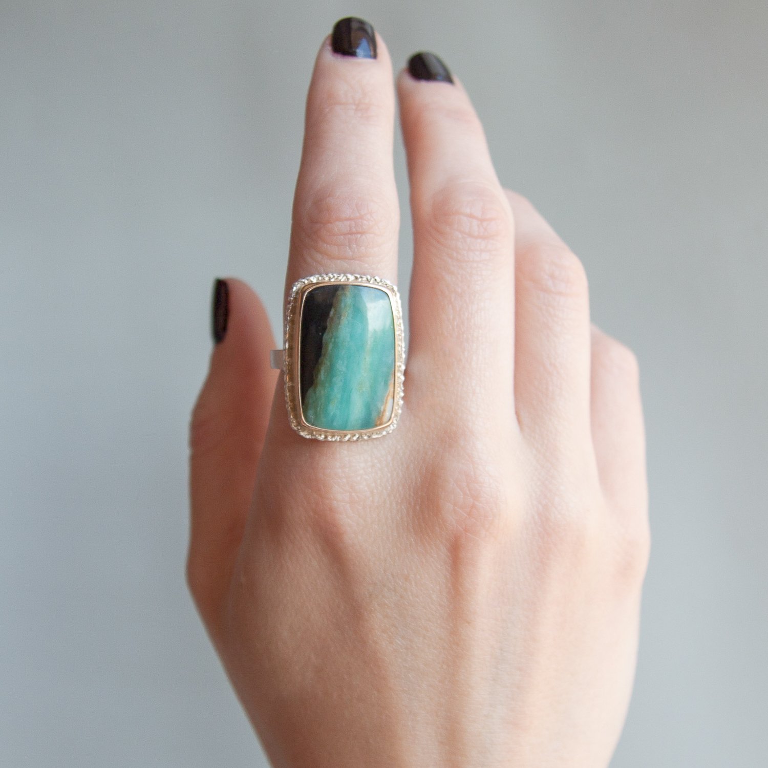 Jamie Joseph: Sterling & 14K gold ring w/vertical rectangular Indonesian Blue Fossilized Opalized Wood on lava platform and X band