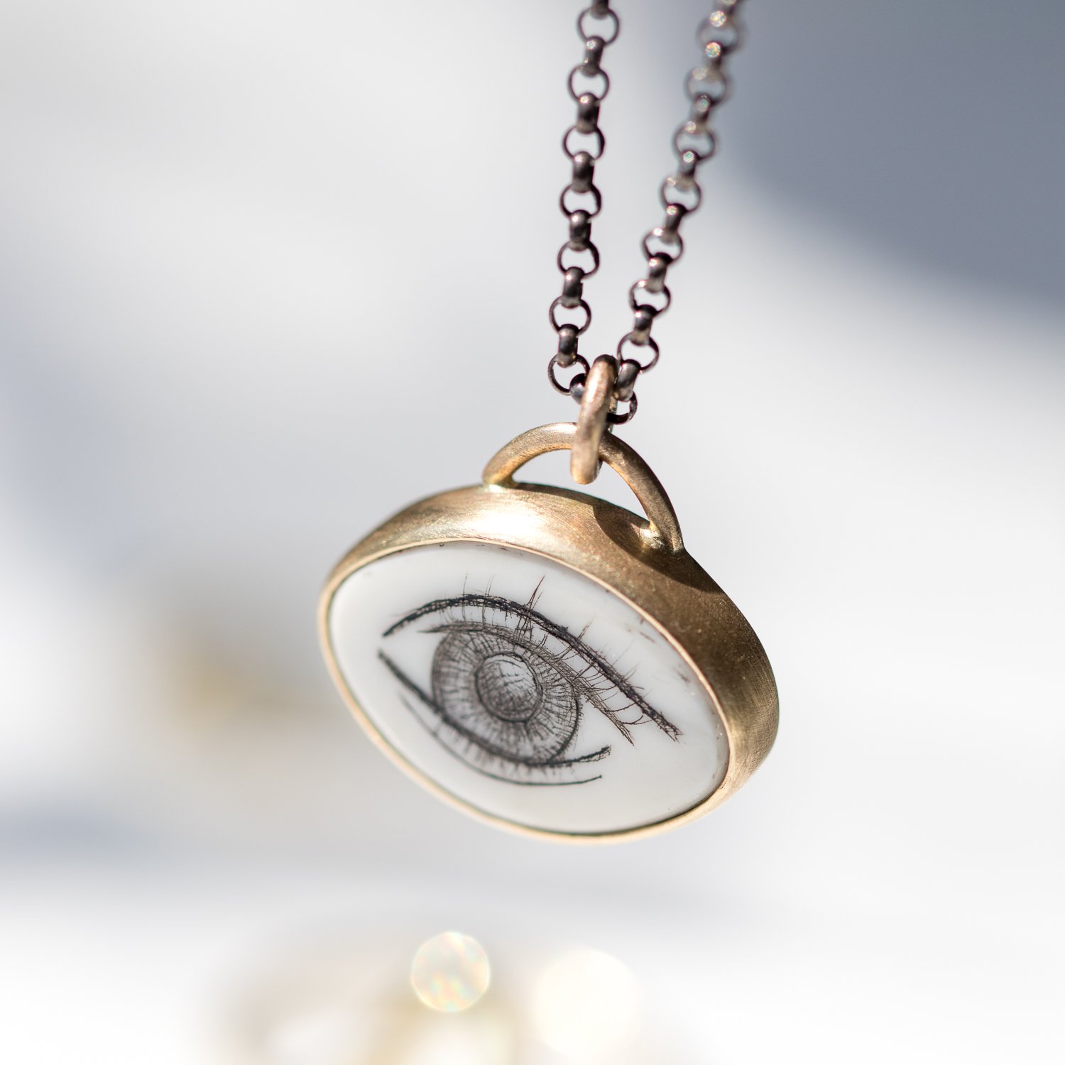 LOVERS EYE QUAHOG SHELL NECKLACE in 14K yellow gold and oxidized sterling silver by jewelry designer Hannah Blount