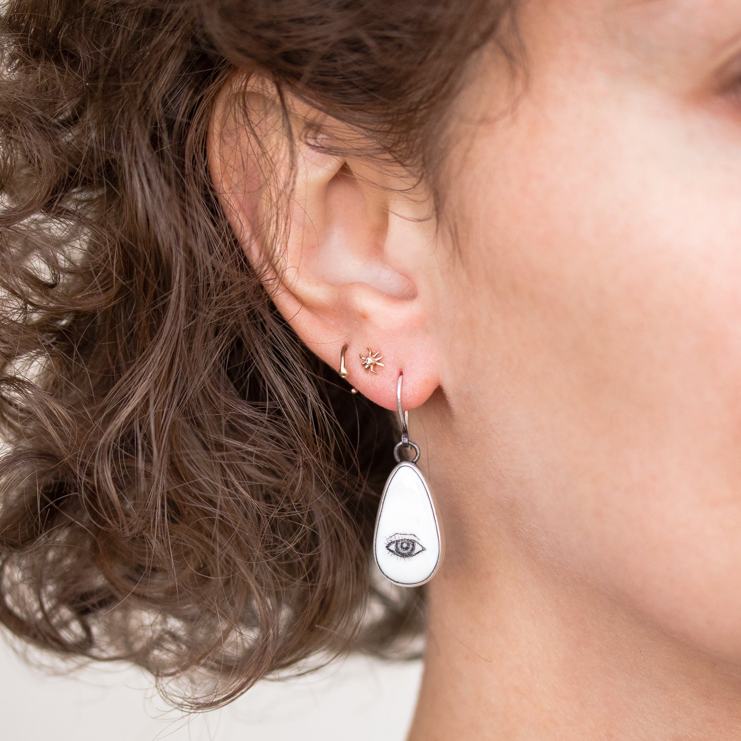 Hannah Blount: Oxidized sterling silver lovers eye quahog shell scimshaw earrings