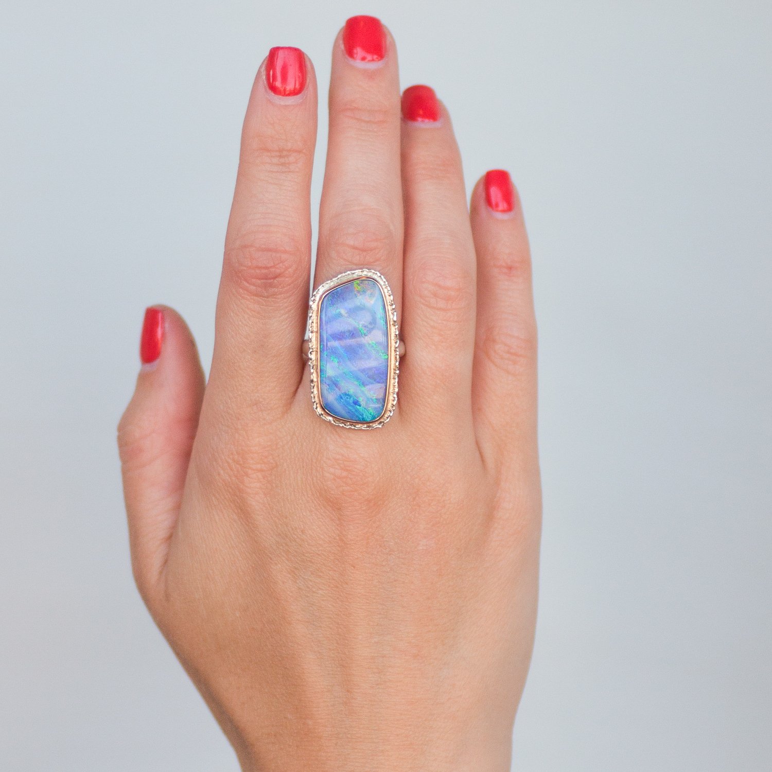 Jamie Joseph: SS & 14K gold ring w/ large vertical asymmetrical boulder opal on lava platform and organic band size 6.5 1 3/16 x 9/16