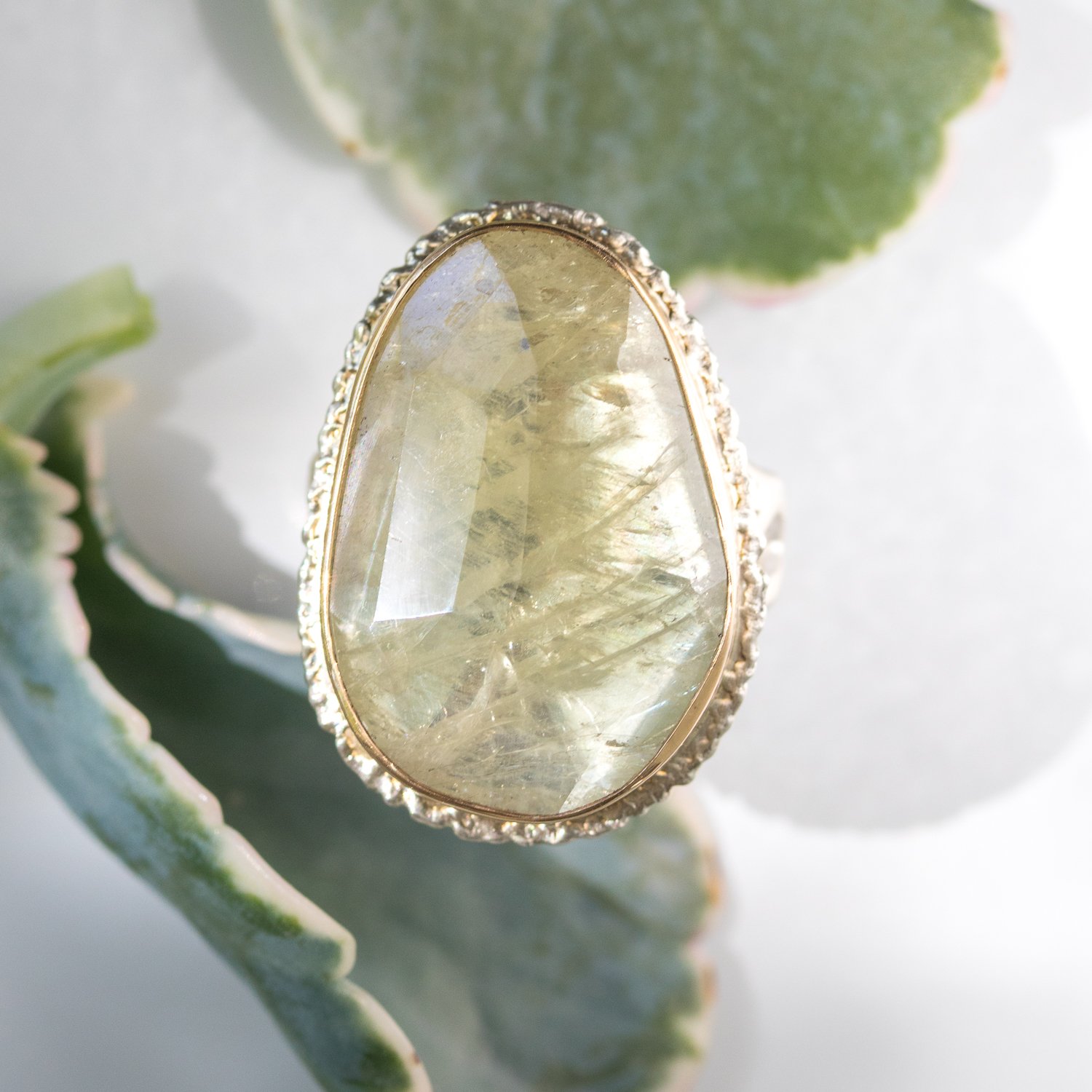 Jamie Joseph: SS and 14K gold ring with vertical asymmetrical faceted green sapphire on lava platform and madrona band size 8 1x11/16
