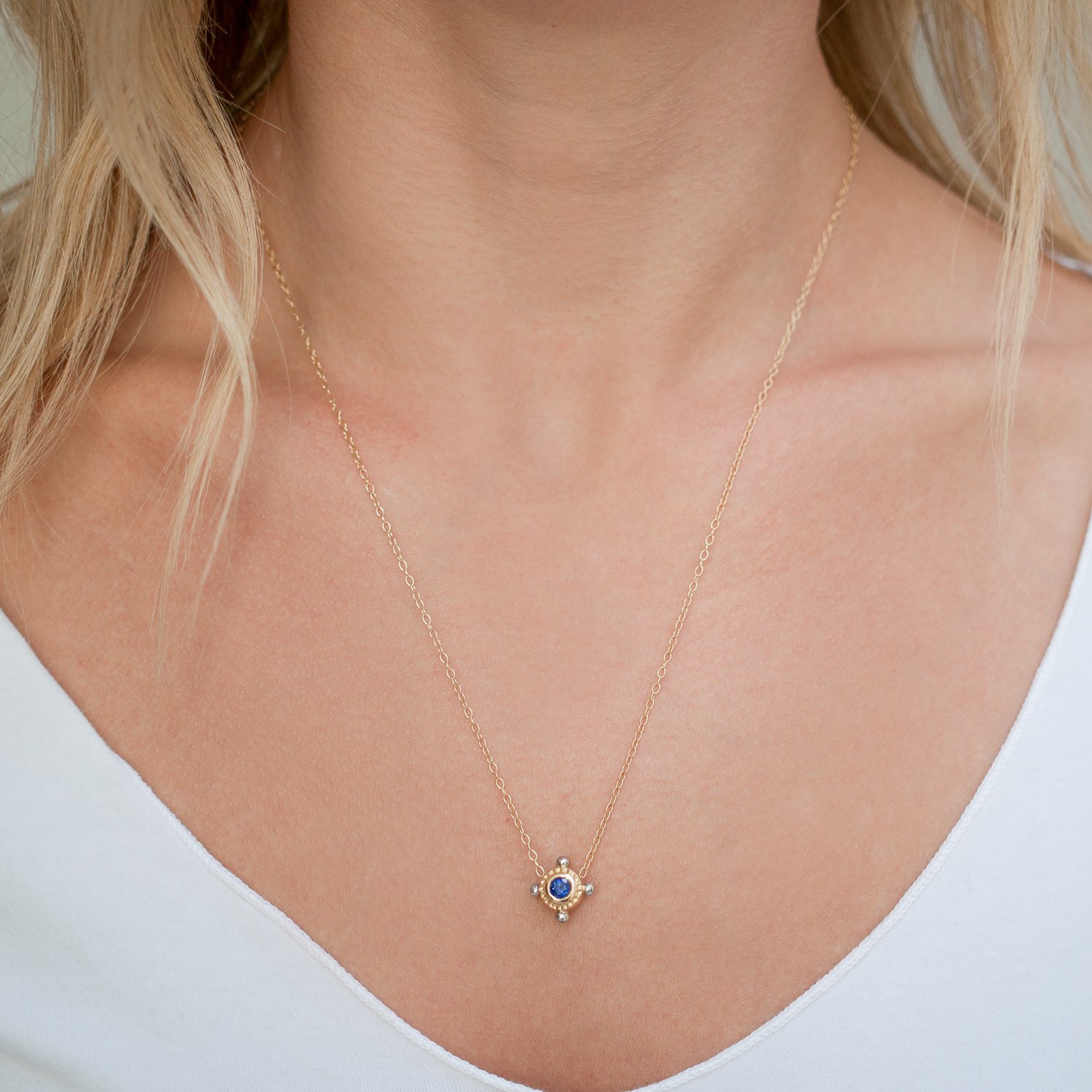 Alison Shiboski: 18K gold, platinum double sided porthole necklace with .41 blue sapphire and .18ct diamond