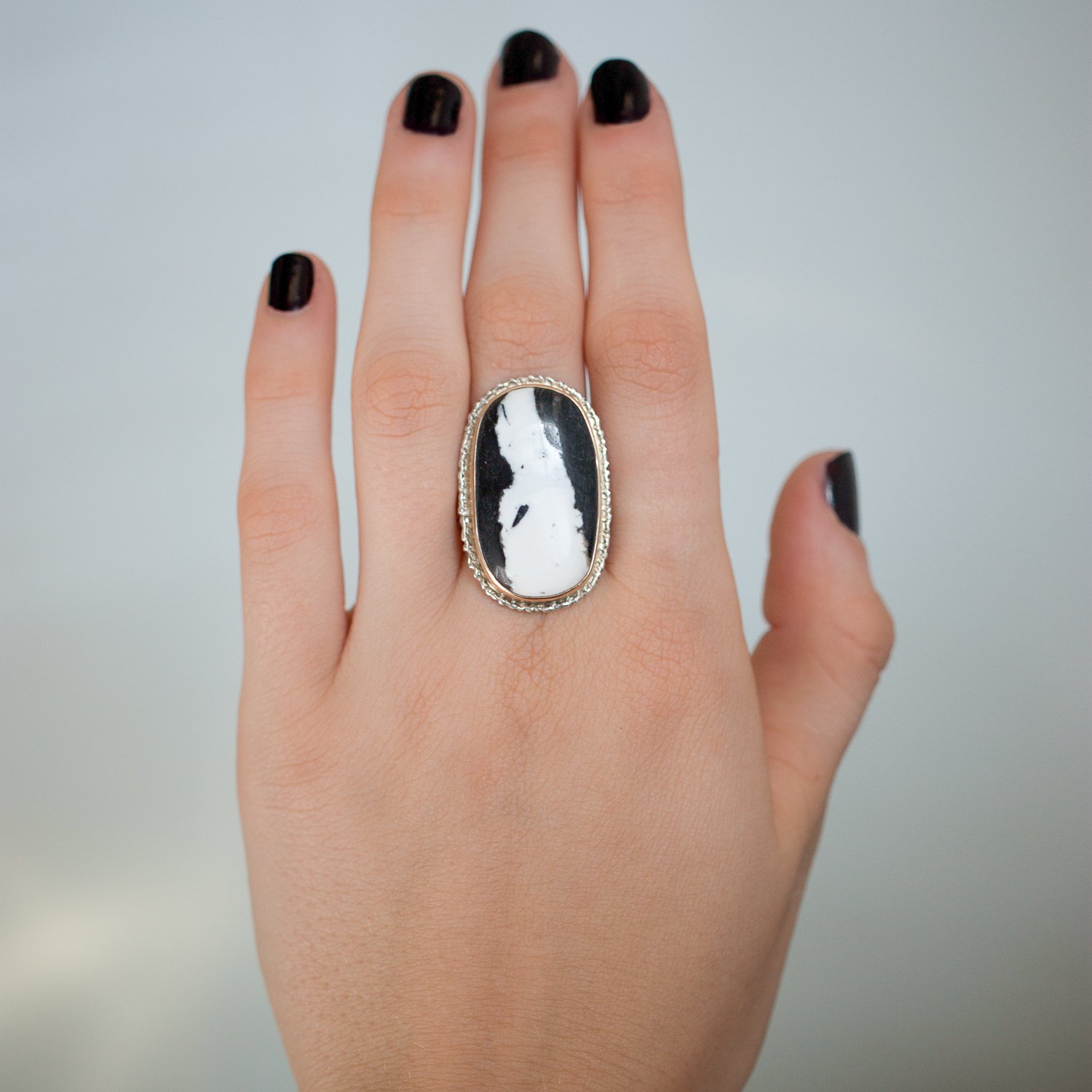 Jamie Joseph: SS and 14k Gold Ring w/ oval white buffalo turquoise on lava platform/ live edge band