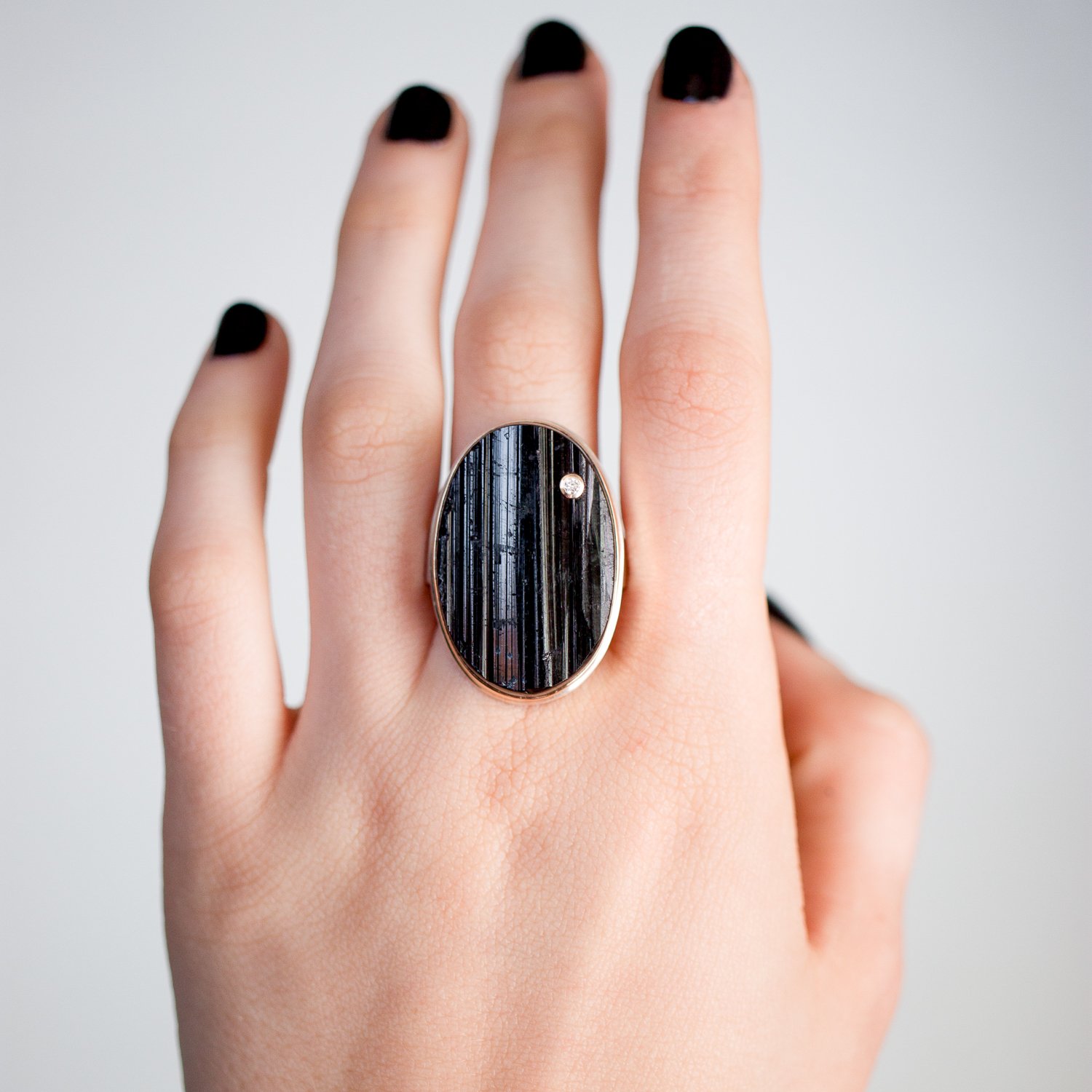 Jamie Joseph: sterling and 14K gold ring w vertical oval surface black tourmaline and .03 ct diamond on tapered Y band