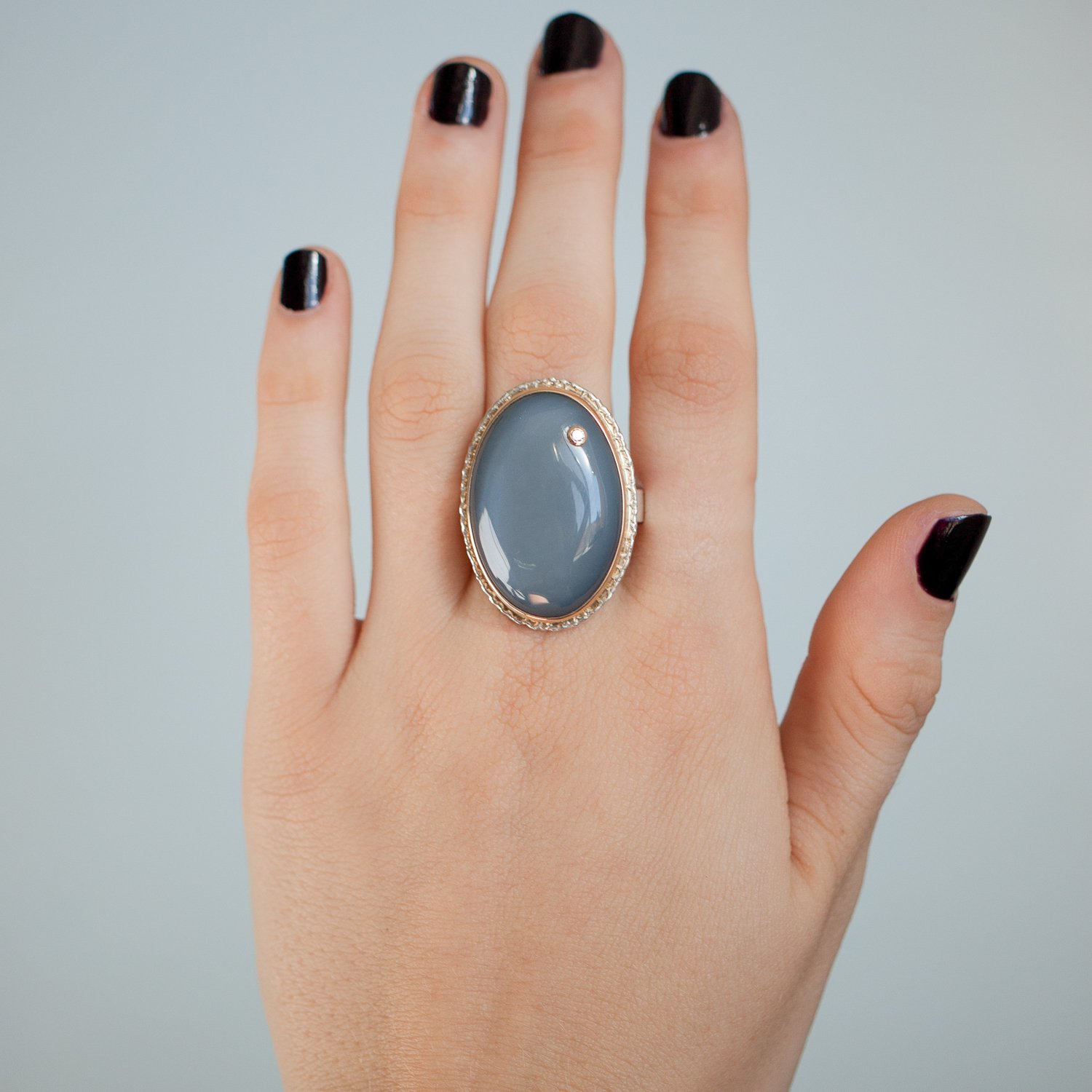 Jamie Joseph: SS and 14k Gold Ring w/ oval grey moonstone and .03 diamond on Y band