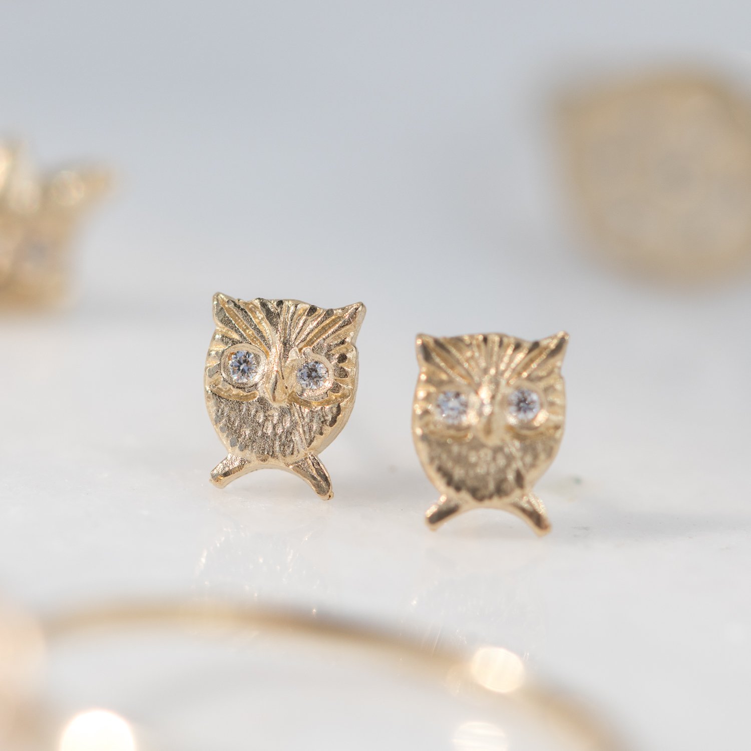 owl post earrings with diamond eyes in 14k yellow gold by jewelry designer Victoria Cunningham at NEWTWIST