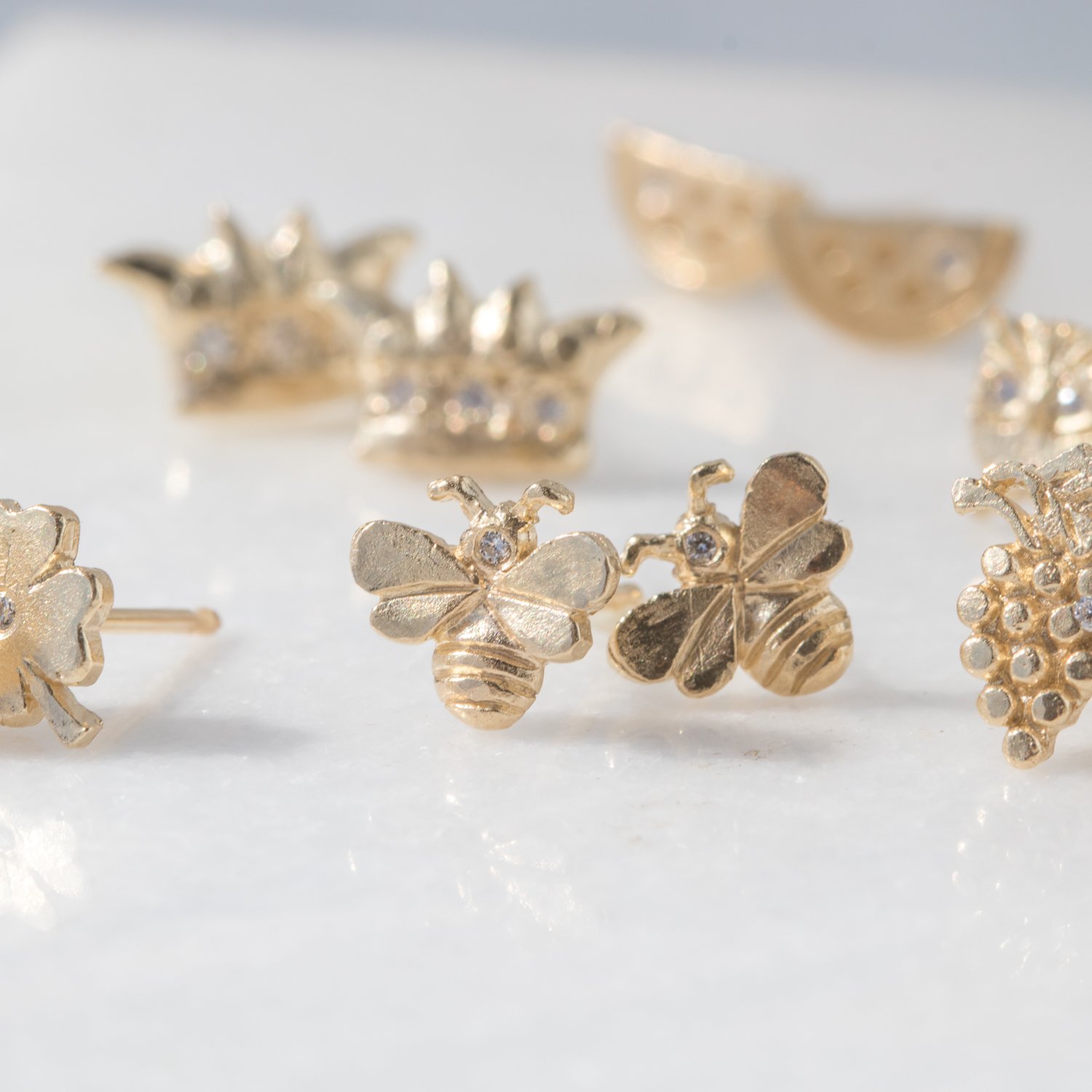 bee post earrings with white diamonds in 14k yellow gold by jewelry designer Victoria Cunningham at NEWTWIST