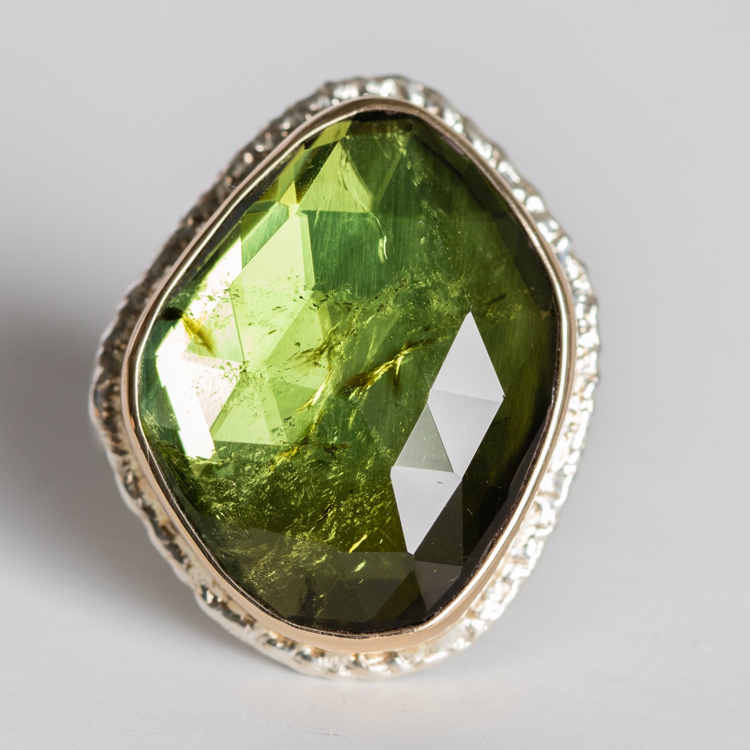 Jamie Joseph: 14K gold and sterling silver ring with vertical asymmetrical rose cut green tourmaline on lava platform comfort band Size 7.5