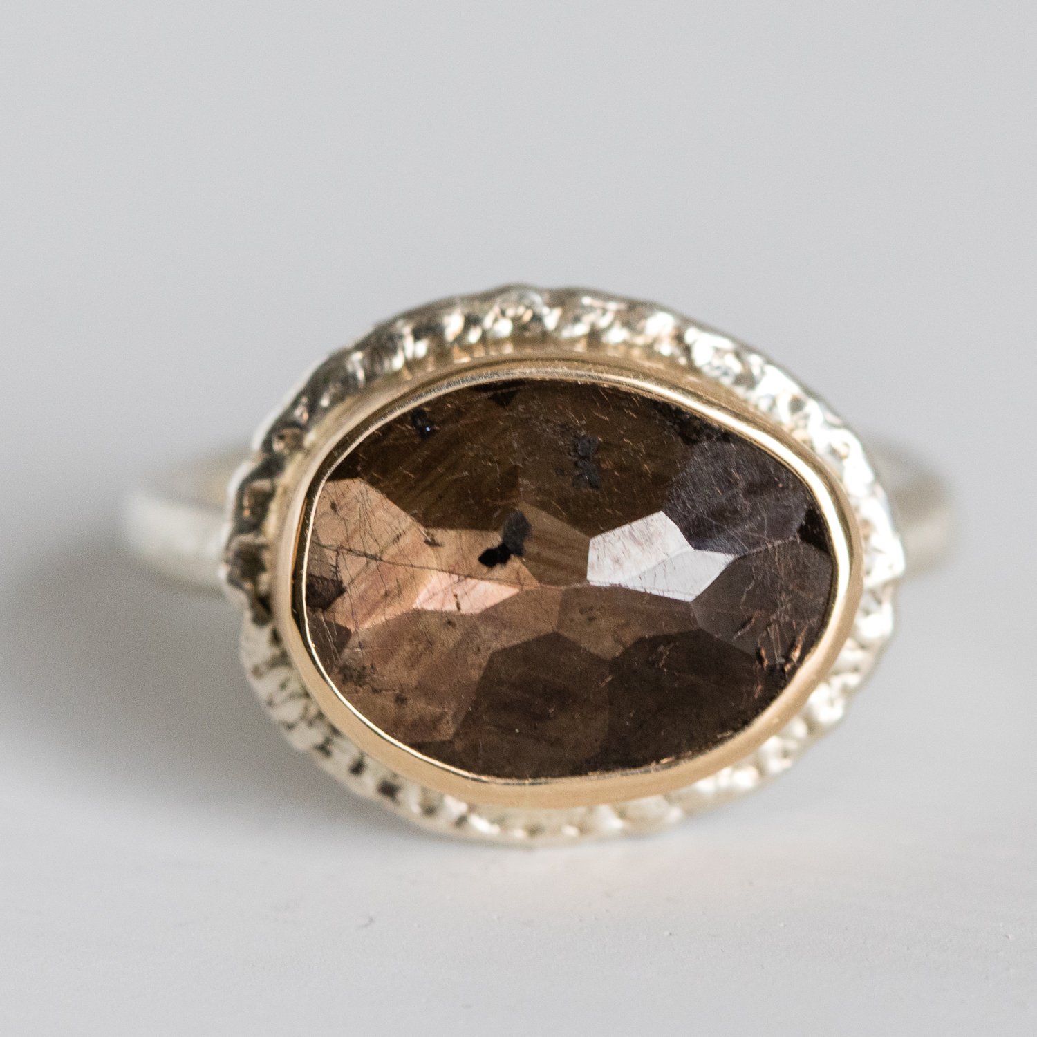 Jamie Joseph: 14K gold and sterling silver ring with small asymmetrical random faceted brown sapphire on Egyptian band Size 7