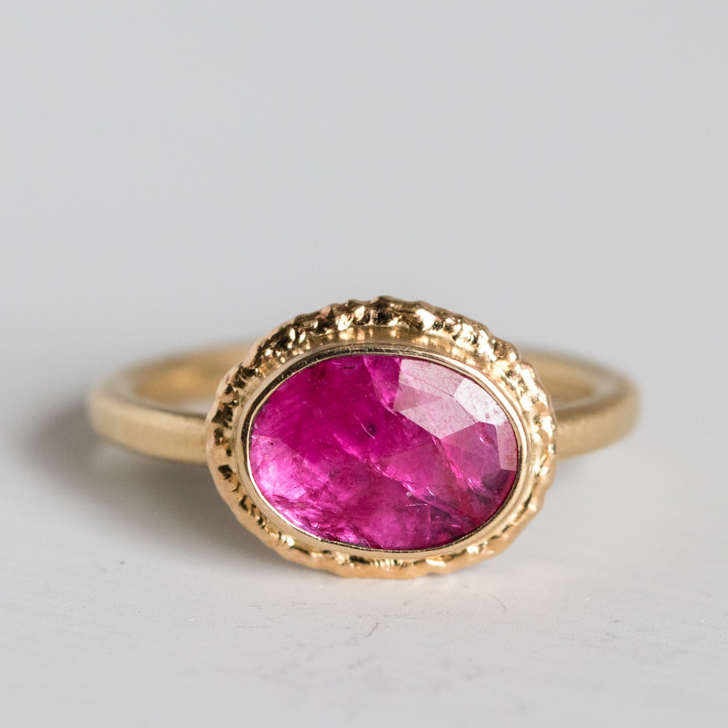Jamie Joseph: 14K gold ring with small oval rose cut Mozambique ruby on ruffled platform Size 6.75