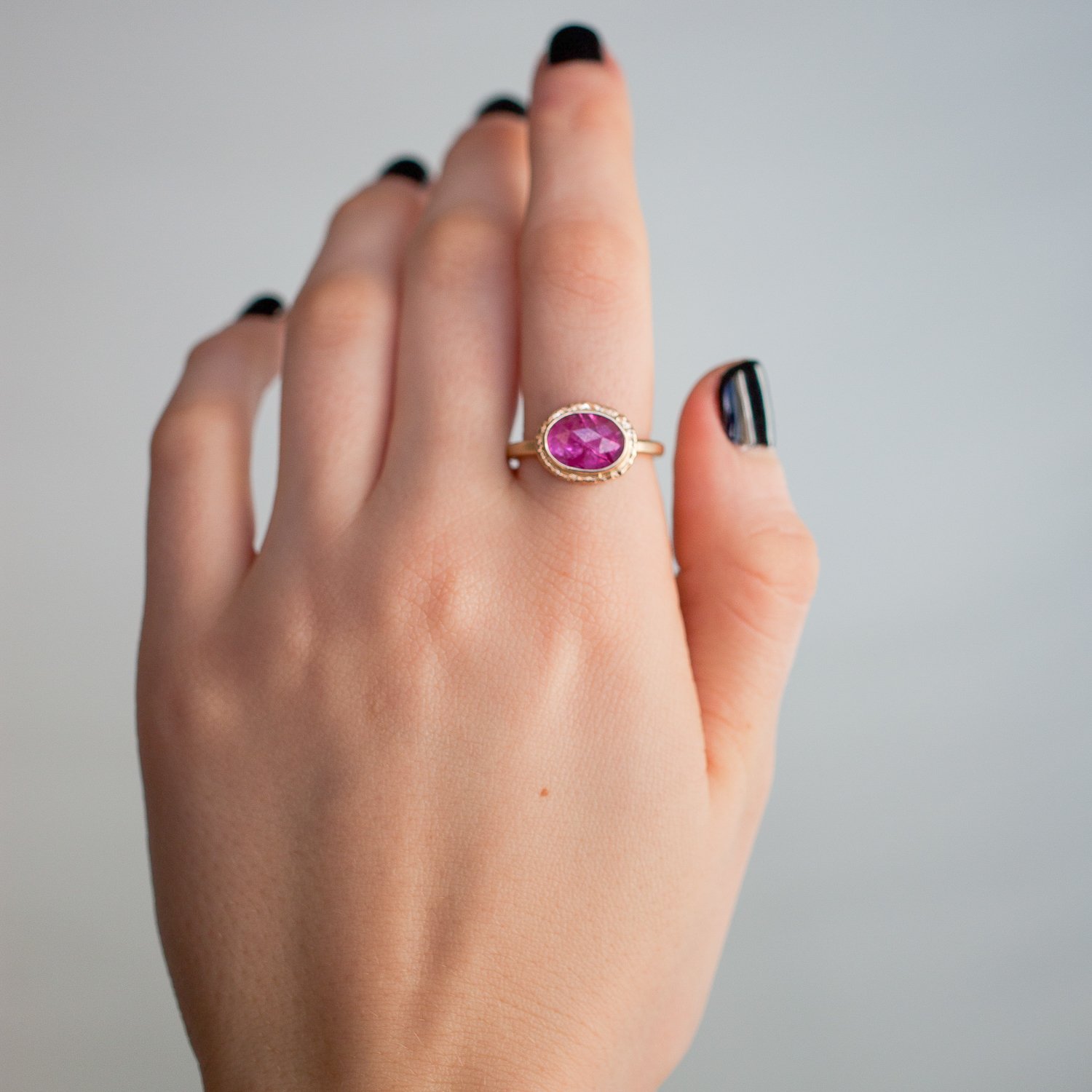 Jamie Joseph: 14K gold ring with small oval rose cut Mozambique ruby on ruffled platform Size 6.75