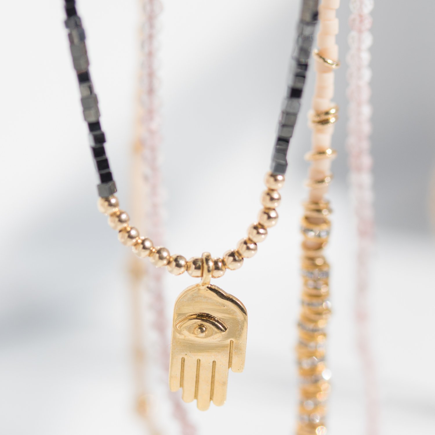 Iwona Ludyga Design: 14K gold fill and silk thread hamsa necklace with hematite beads