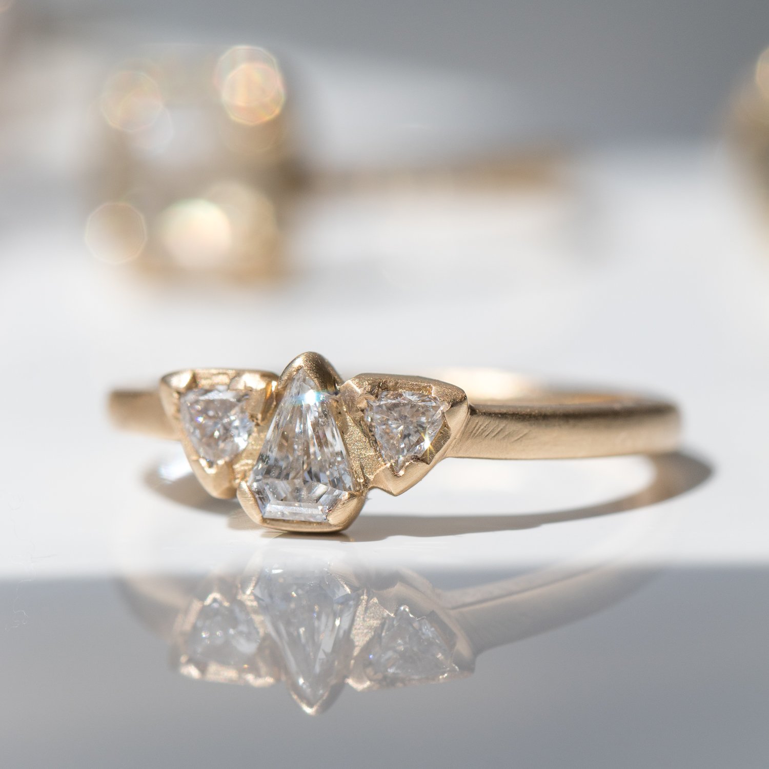 triple shield diamond ring