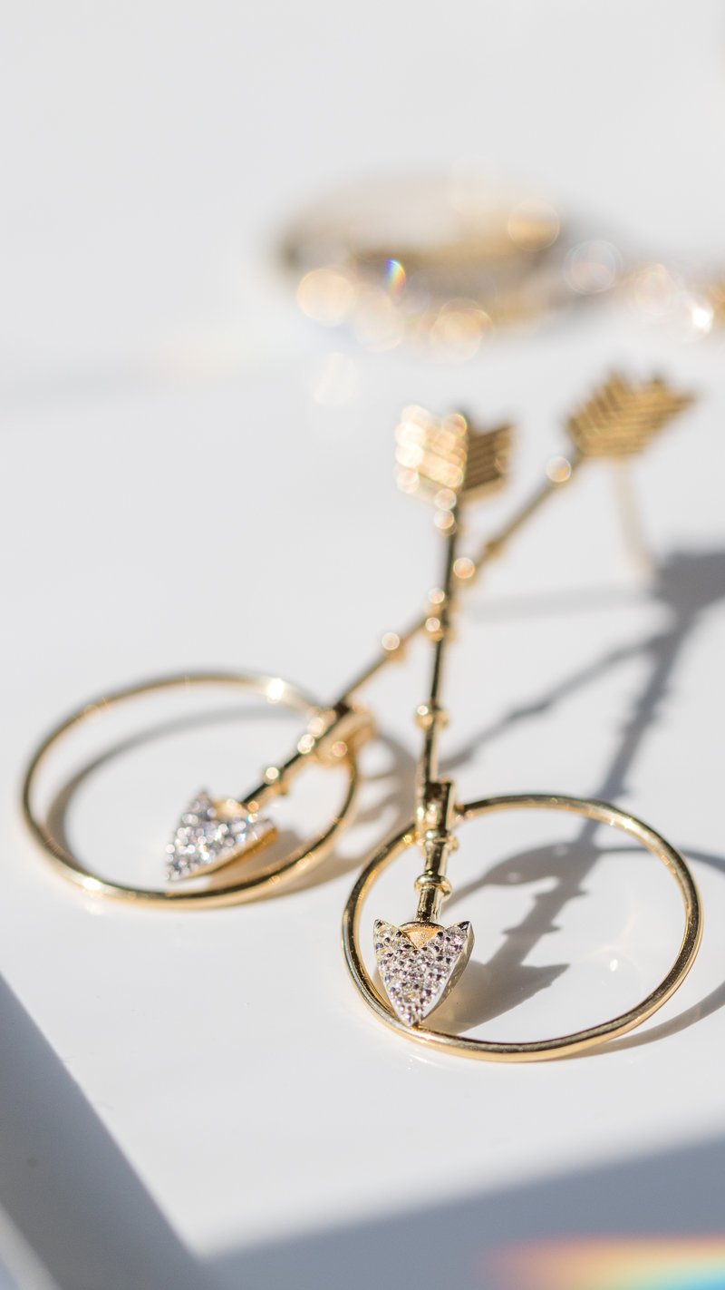Gold diamond crossbow earrings by Kismet by Milka