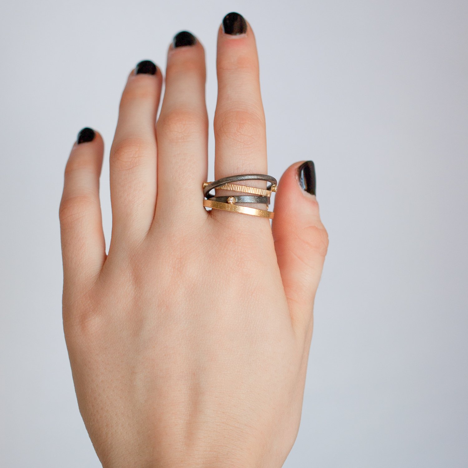 Todd Reed: 18k gold and silver innertwined ring with scattered white brilliant diamonds (0.075 ctw)