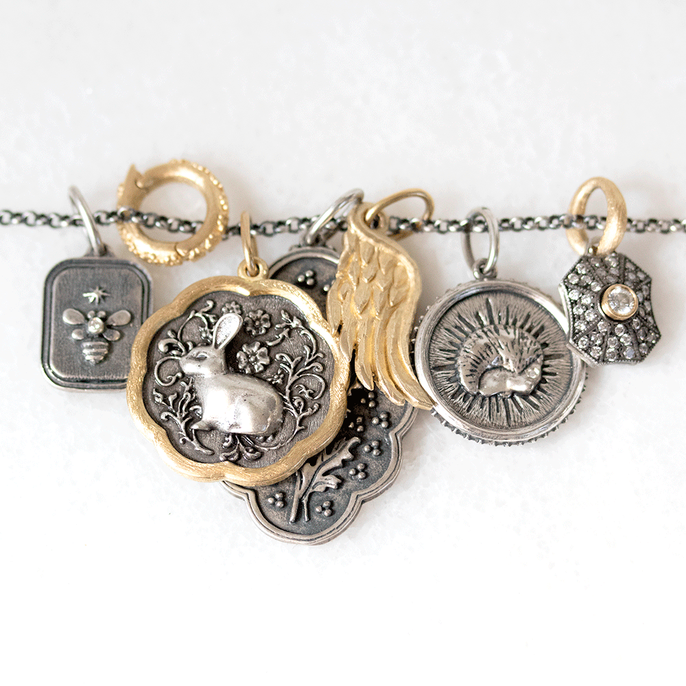 Gold and silver charms by Erica Molinari