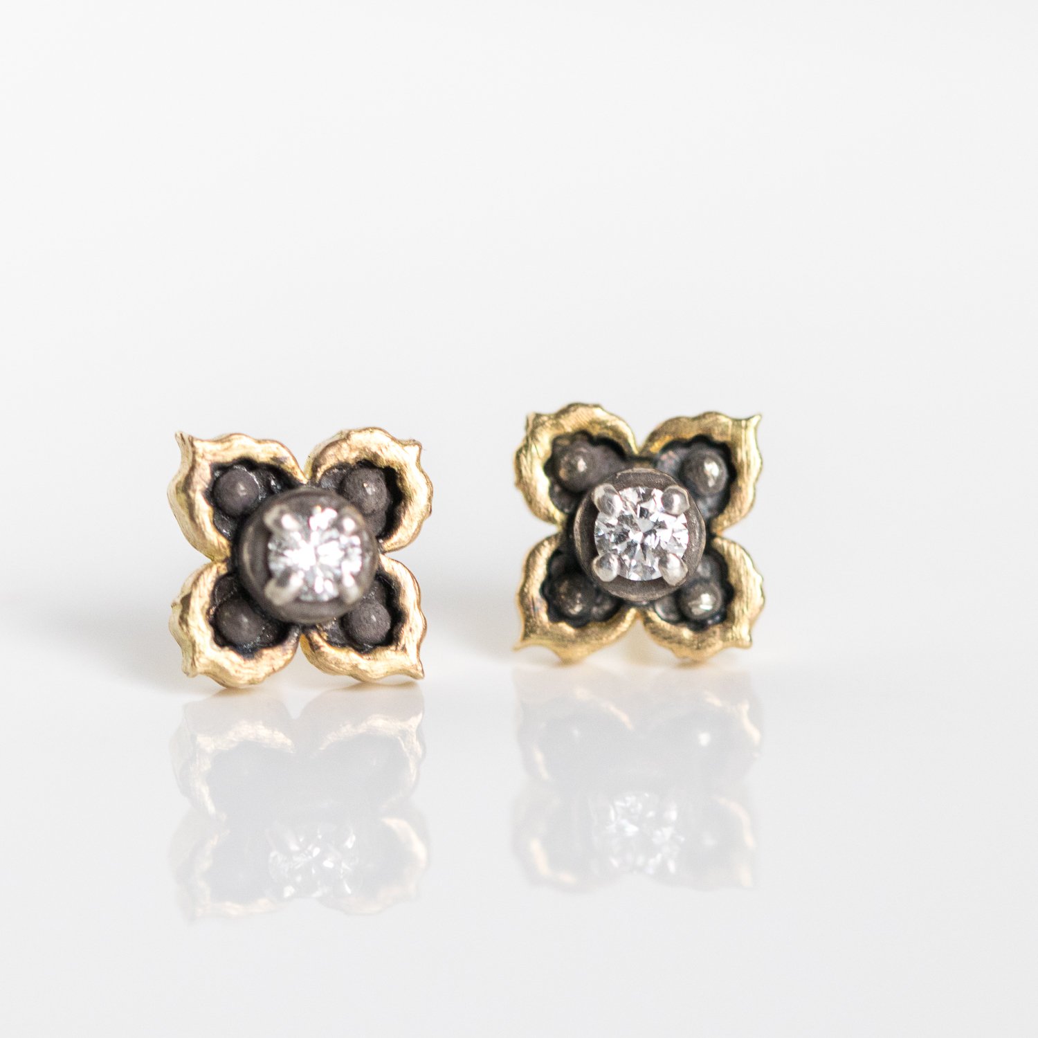 Erica Molinari Trunk Show: ss and 18k ornate 4 point star stud .12cts