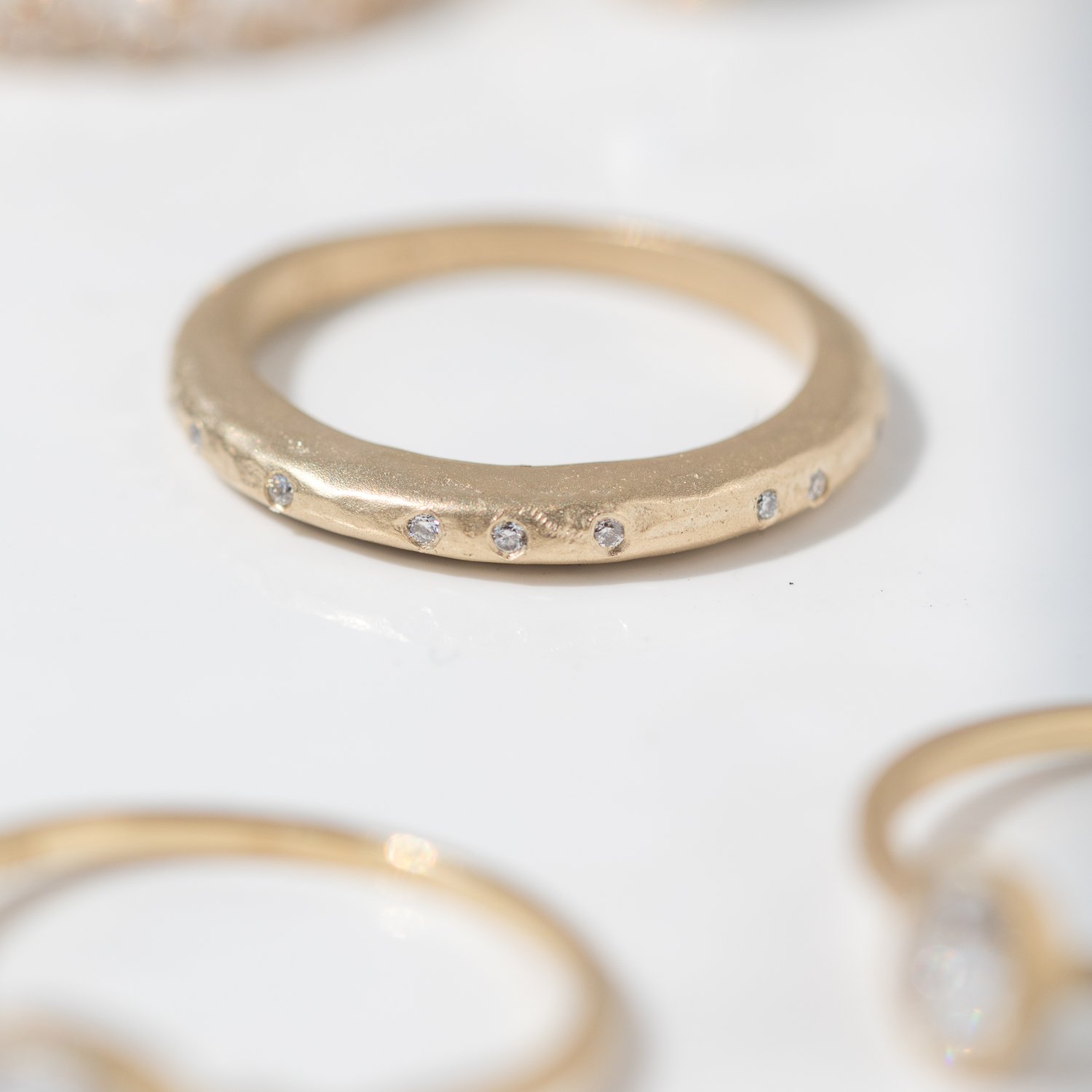 High hammered band in 14k yellow gold with diamonds by Victoria Cunningham