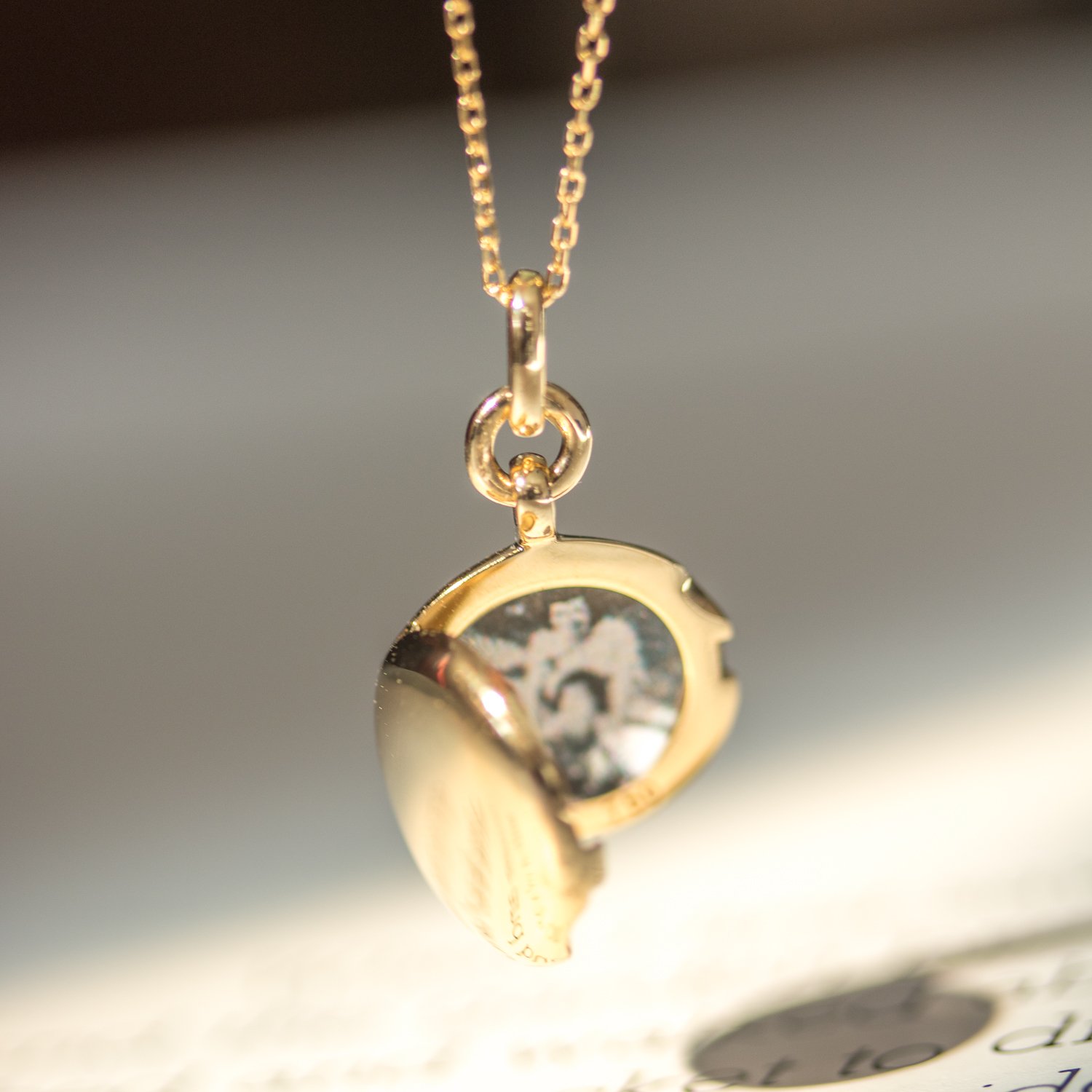 Gold slim round locket by jewelry designer Monica Rich Kosann