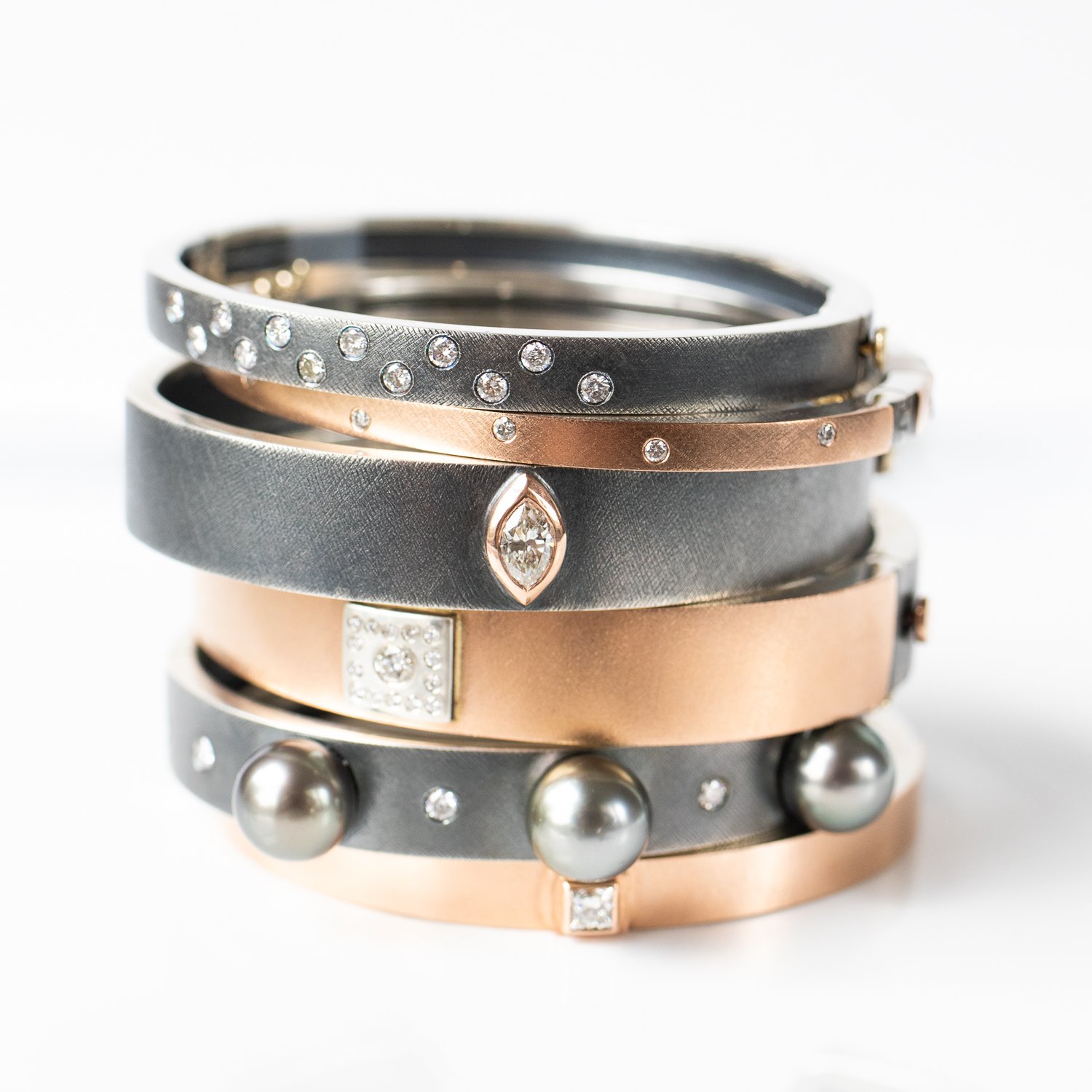 Oxidized sterling silver and rose gold diamond bracelets by jewelry designer Rene Escobar