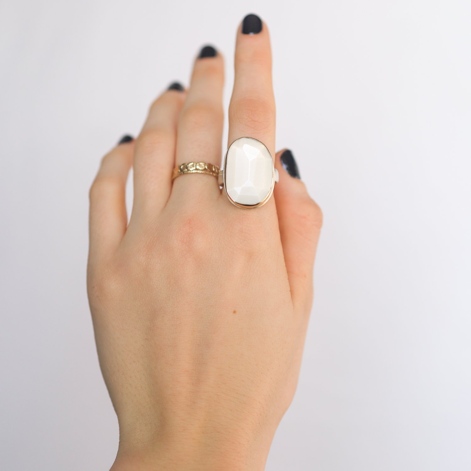 Jamie Joseph: SS & 14k gold ring with vertical asymmetrical faceted white moonstone on comfort band