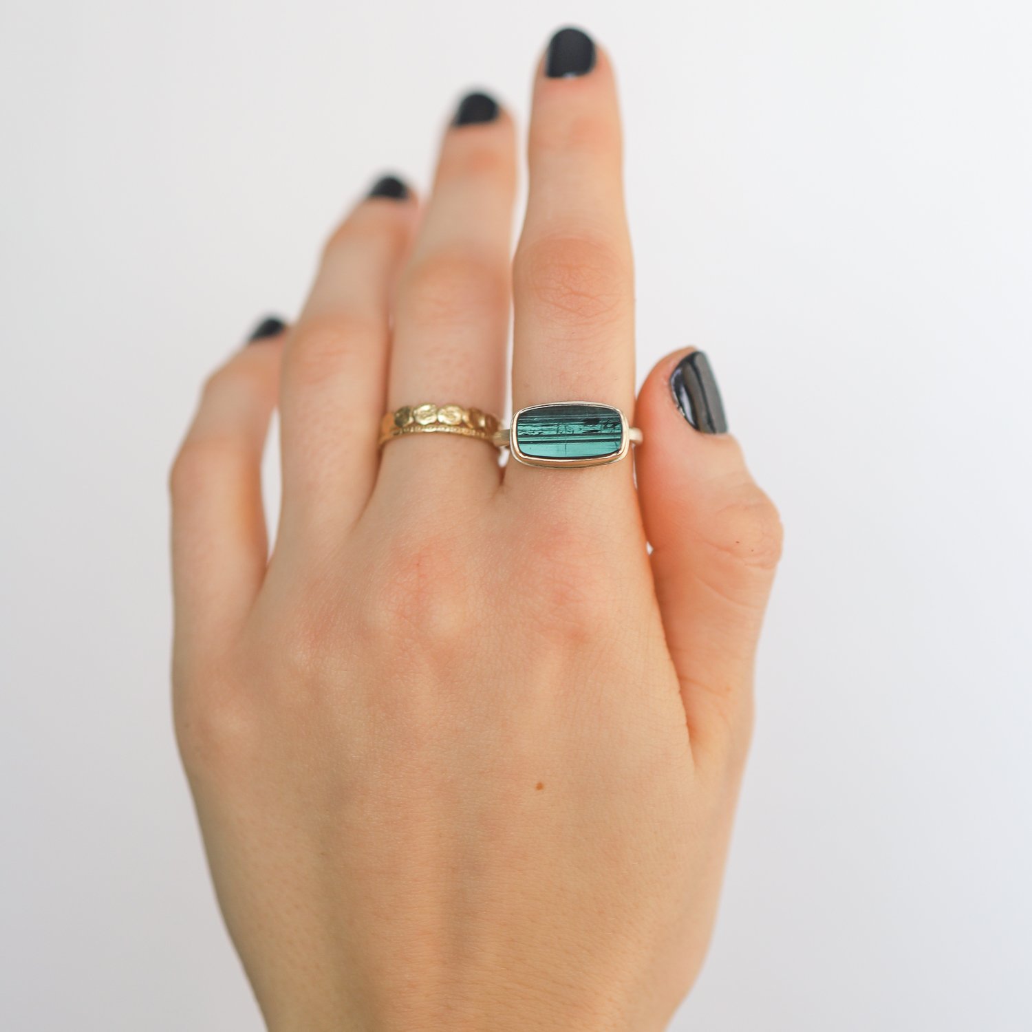 Jamie Joseph: SS & 14k gold ring with small rectangular surface cut green tourmaline on dent band