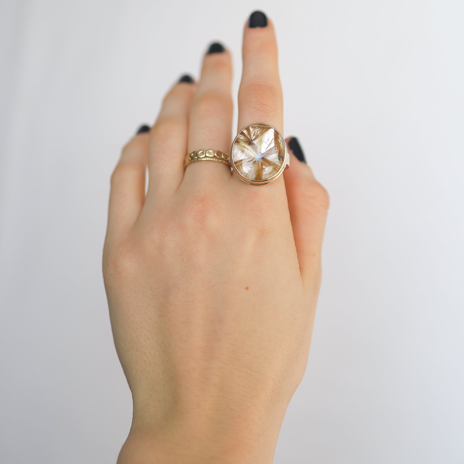 Jamie Joseph: SS & 14k gold ring with vertical oval smooth star golden rutilated quartz on live edge band