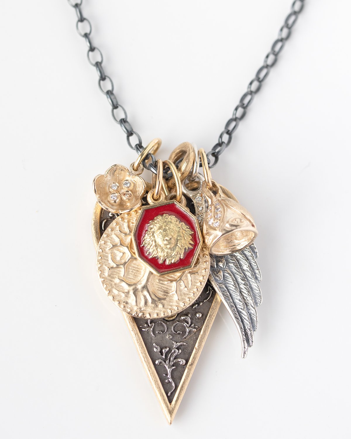 Gold, silver, and enamel necklace charms by jewelry designer Erica Molinari