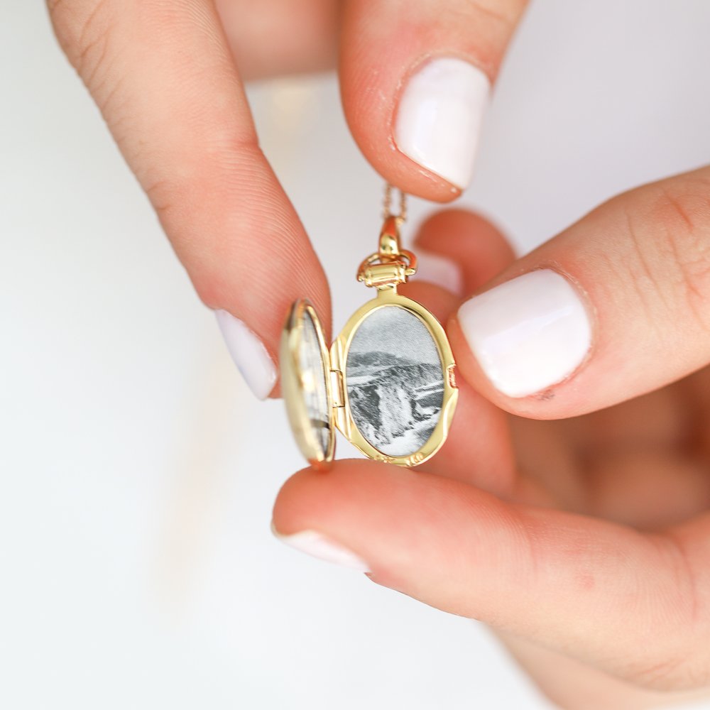 Slim round locket in 18k yellow gold by jewelry designer Monica Rich Kosann