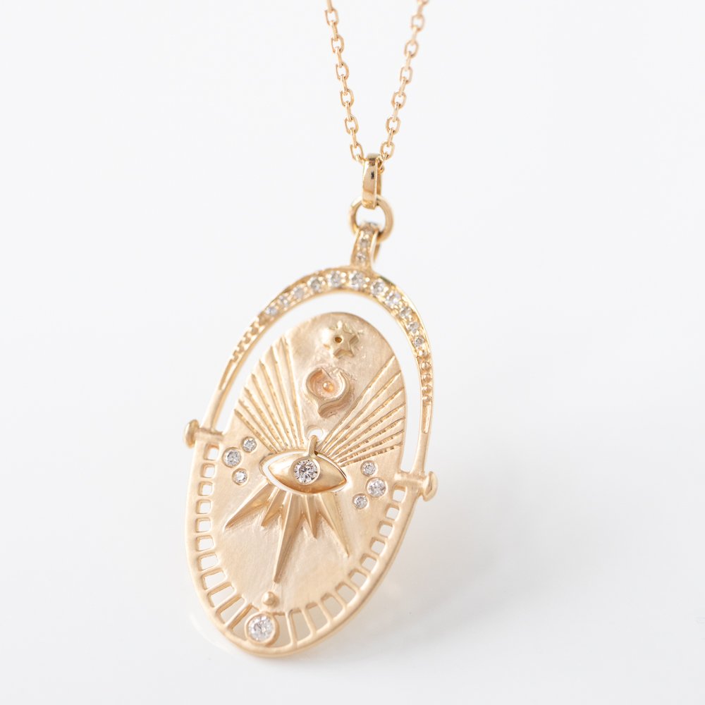 Gold and diamond mandala sun necklace by jewelry designer Celine Daoust